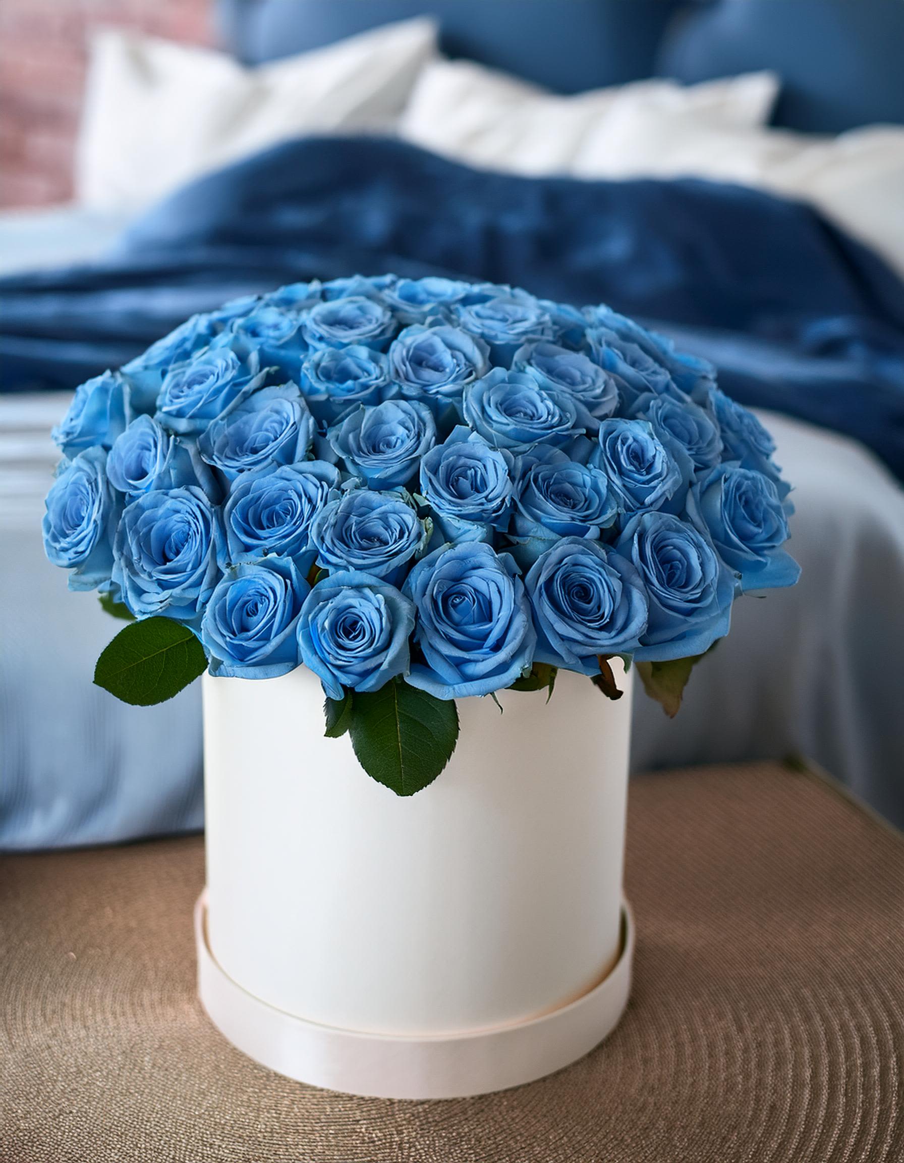 The Starry Sky - Stunning beauty of blue sky roses in a chic hatbox. This vibrant arrangement offers a luxurious and eye-catching gift for any occasion. These unique roses are sure to impress. Ideal for memorable events or a special surprise.