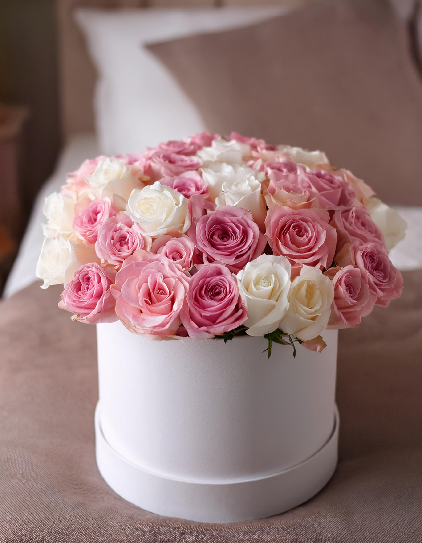 Rose Reverie Rose Reverie - Enjoy the beauty of our luxurious hatbox arrangement, featuring a lovely mix of white and soft pink roses. Perfect for any celebration, this floral gift adds a touch of elegance and makes your expression of love truly memorable. Whether it's a special occasion or just because.