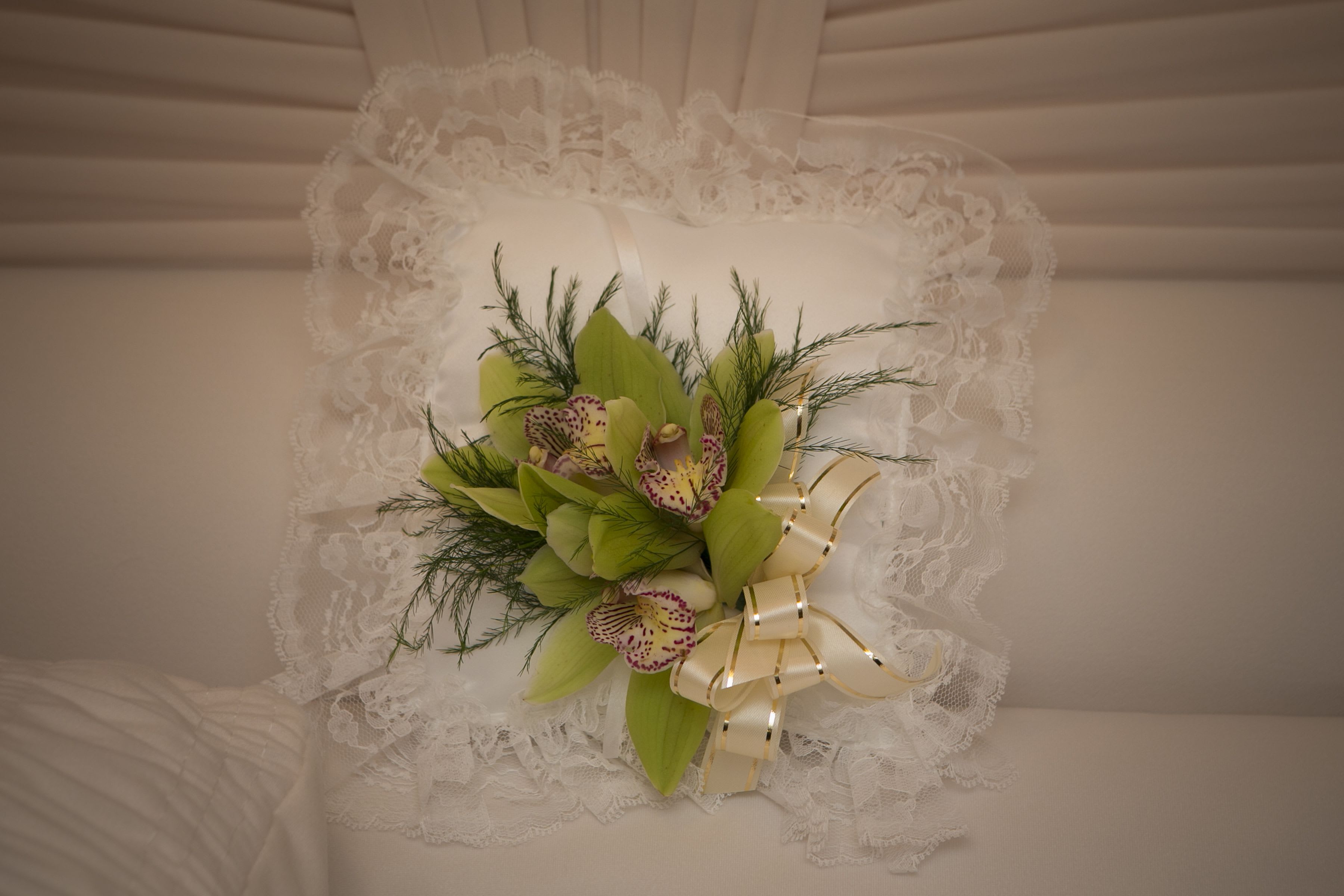 Satin Casket Pillow of Orchids Satin Casket Pillow of Orchids - Satin casket pillow of green orchids add that special touch. During the order process, you can indicate where to send the flowers. Order by 10am to ensure delivery for 2pm showings at wakes. As Shown : CP-1