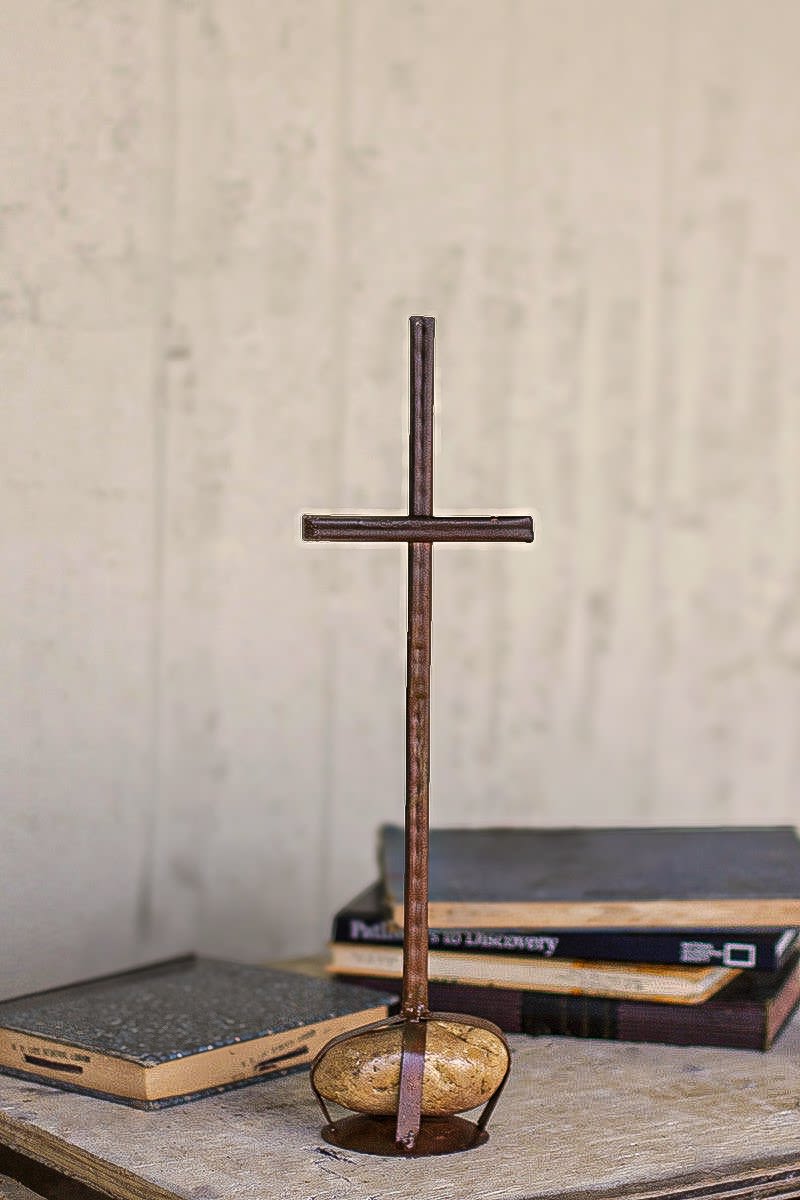 Rustic Cross with caged rock base Rustic Cross with caged rock base - A striking token of faith and love... a memorable gift for friend or kin. A rustic cross fashioned from scrap metal and anchored with a caged riverstone base. Handmade, each vary in size.. but rough measurements are 5.5" x 4" x 16"t. This is delivered with your gift message tied onto it.