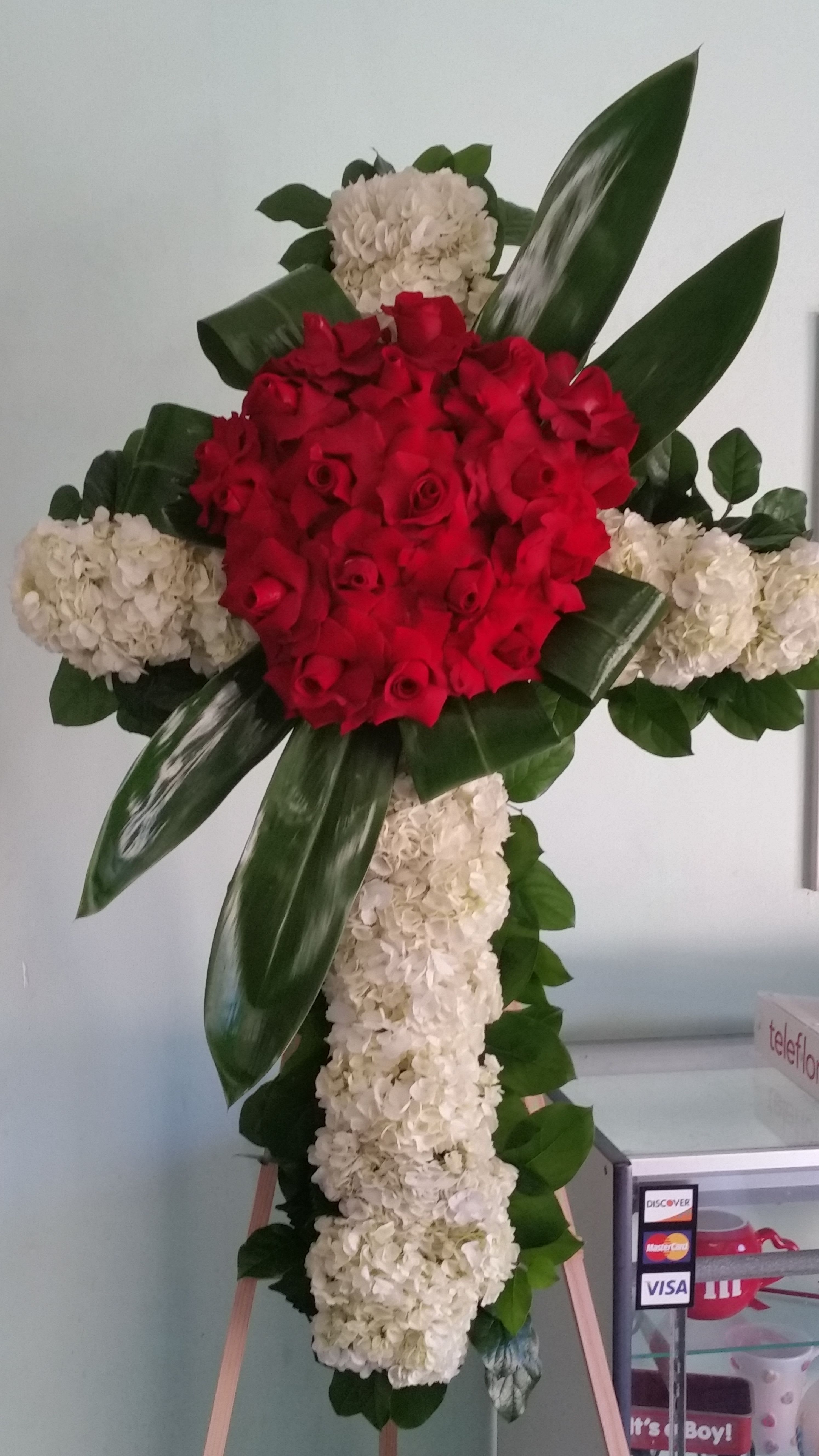 Cross of Memories  - Cross with white hydrangeas and red roses.