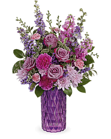 Teleflora's Amazing Amethyst Bouquet Teleflora's Amazing Amethyst Bouquet - Lavish mom with luxury! This magnificent lavender rose bouquet reaches new heights of glamour in a stunning diamond-cut, amethyst-hued vase. This amazing bouquet includes lavender roses, purple larkspur, pink stock, purple carnations, lavender cushion spray chrysanthemums, miniature pink carnations, purple sinuata statice, lemon leaf and pitta negra. Delivered in Teleflora's Amazing Amethyst vase. Orientation: All-Around