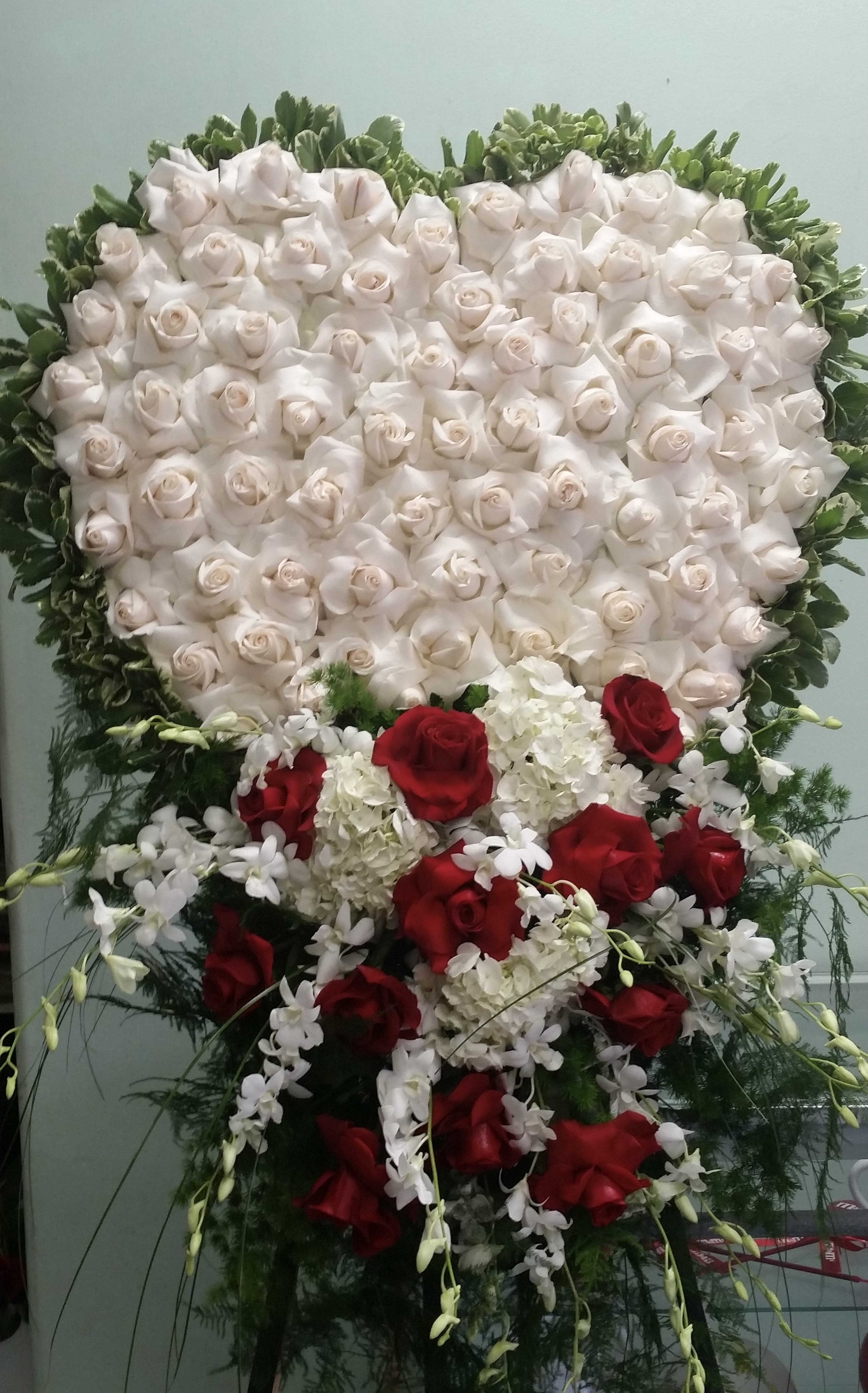 Forever in our Hearts Forever in our Hearts - Closed Heart with white roses, red roses, white hydrangeas, and white orchids.