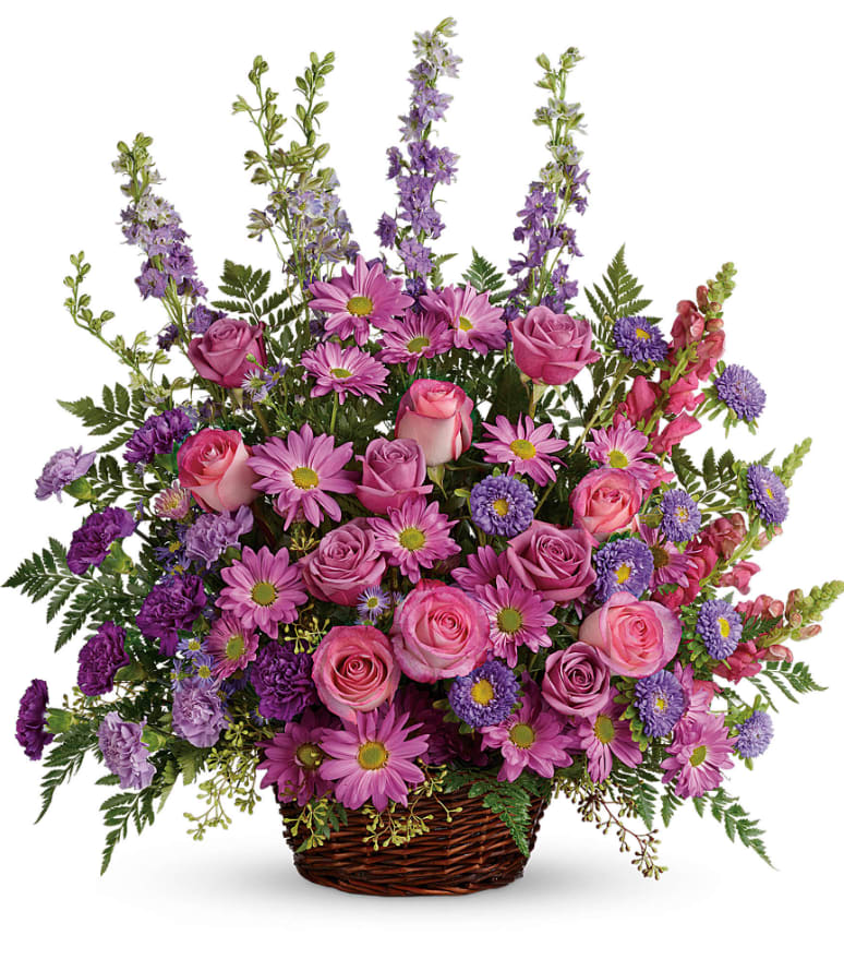 Gracious Lavender Basket - Soothing lavender, respectful purple and compassionate pinks are combined beautifully in this basket overflowing with pretty flowers, sincerity and sympathy. A lovely way to share your thoughts and pay tribute to someone special. A profusion of purple, pink and lavender blooms such as roses, carnations, larkspur, matsumoto and monte cassino asters and much more are delivered in a round wicker basket. Approximately 27 3/4&quot; W x 28 1/2&quot; H