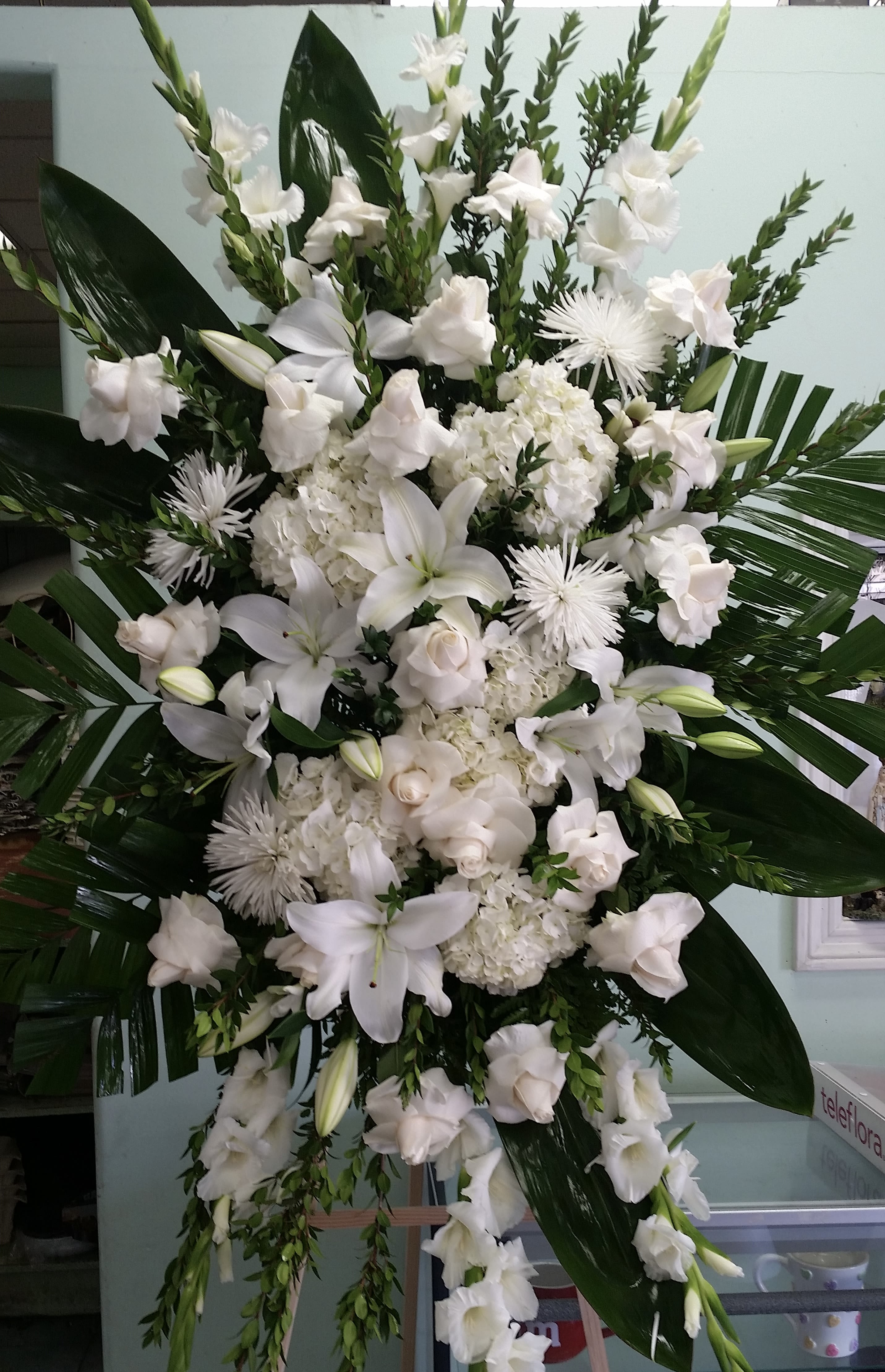 Soulful Serenade  - Spray with white roses, white mums, white lilies, and white gladiolus.