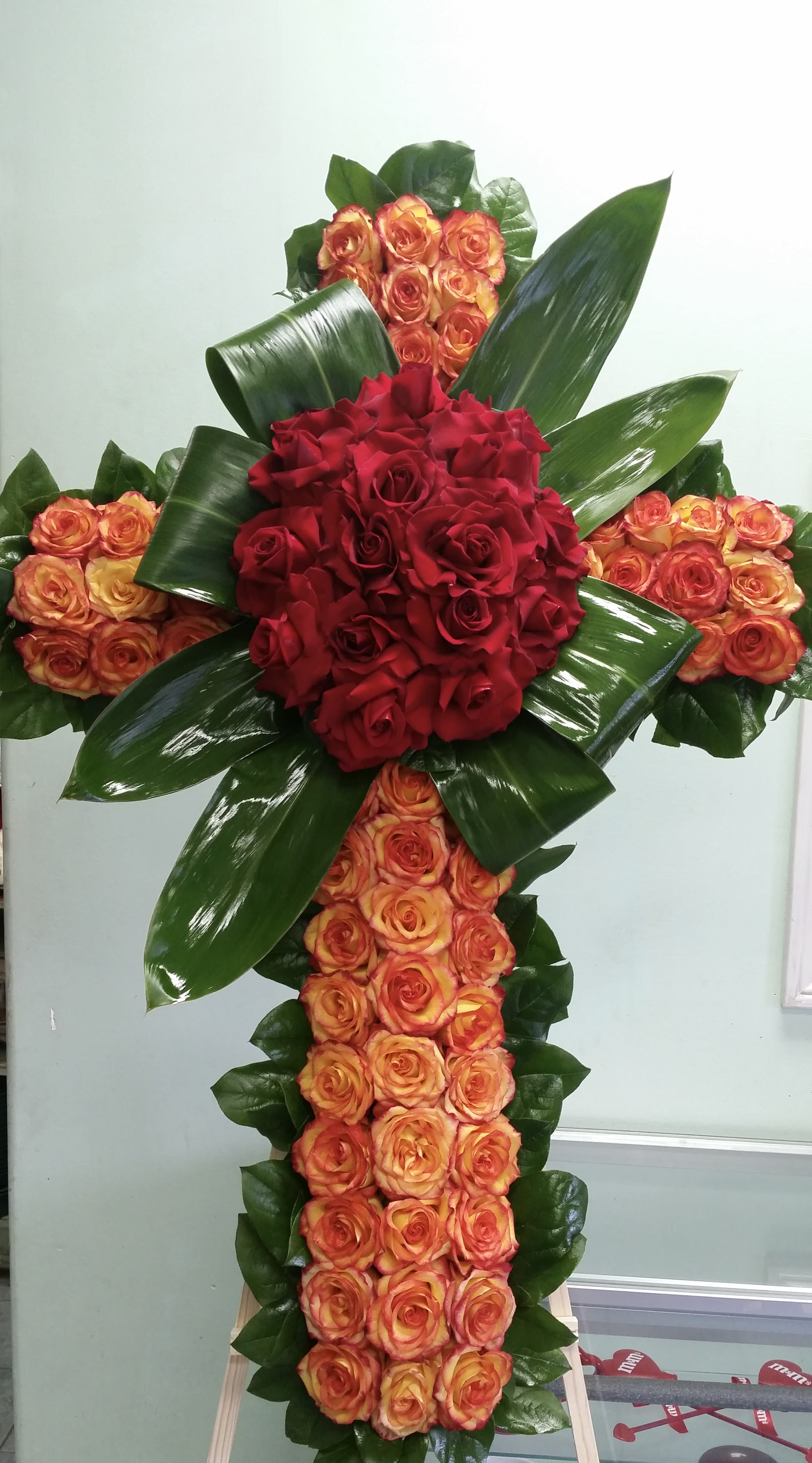 Peaceful Sunset Peaceful Sunset - Cross with orange roses and red roses.