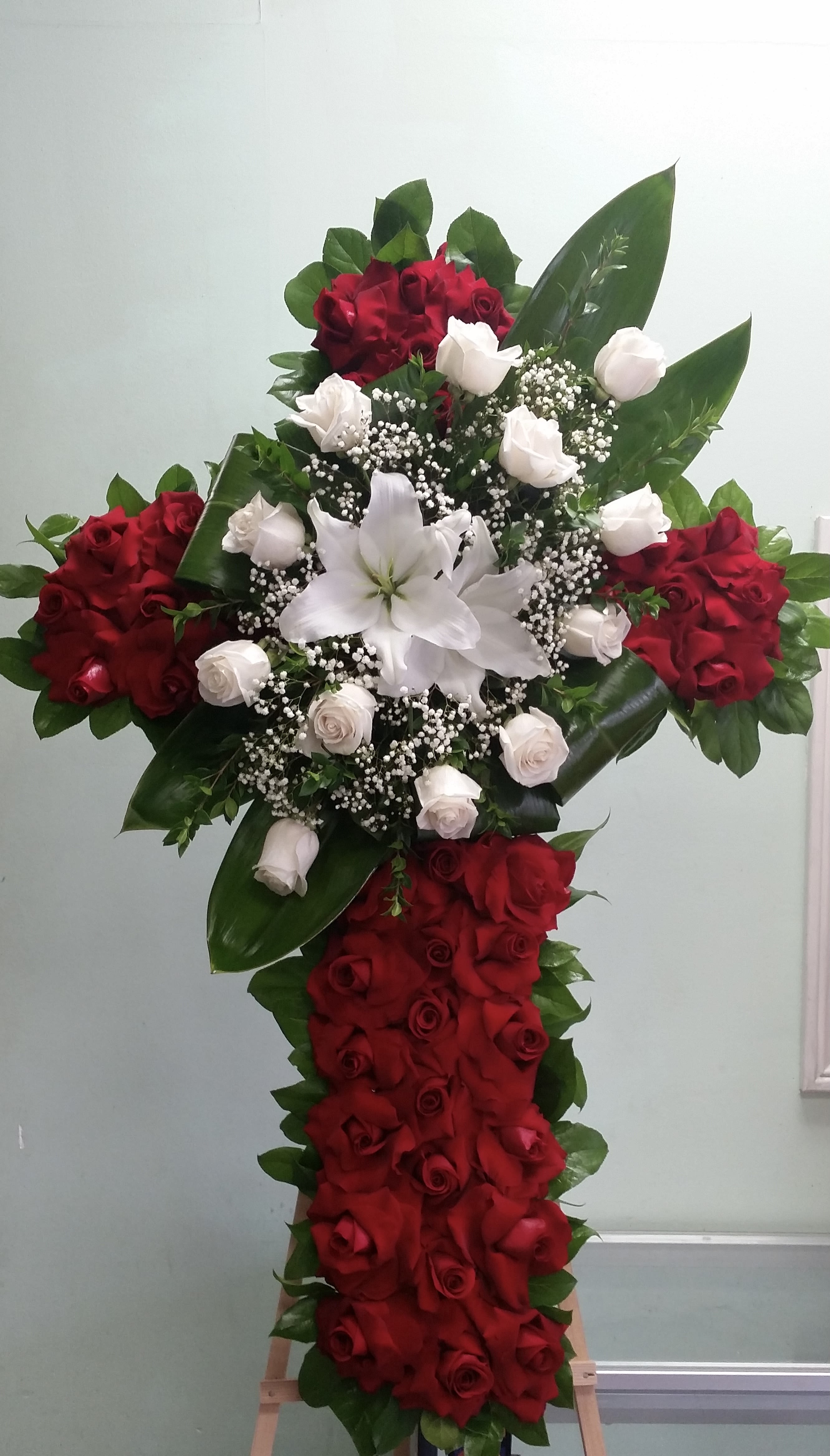 Eternal Cross of Love Eternal Cross of Love - Cross with red roses, white rose, and white lilies.