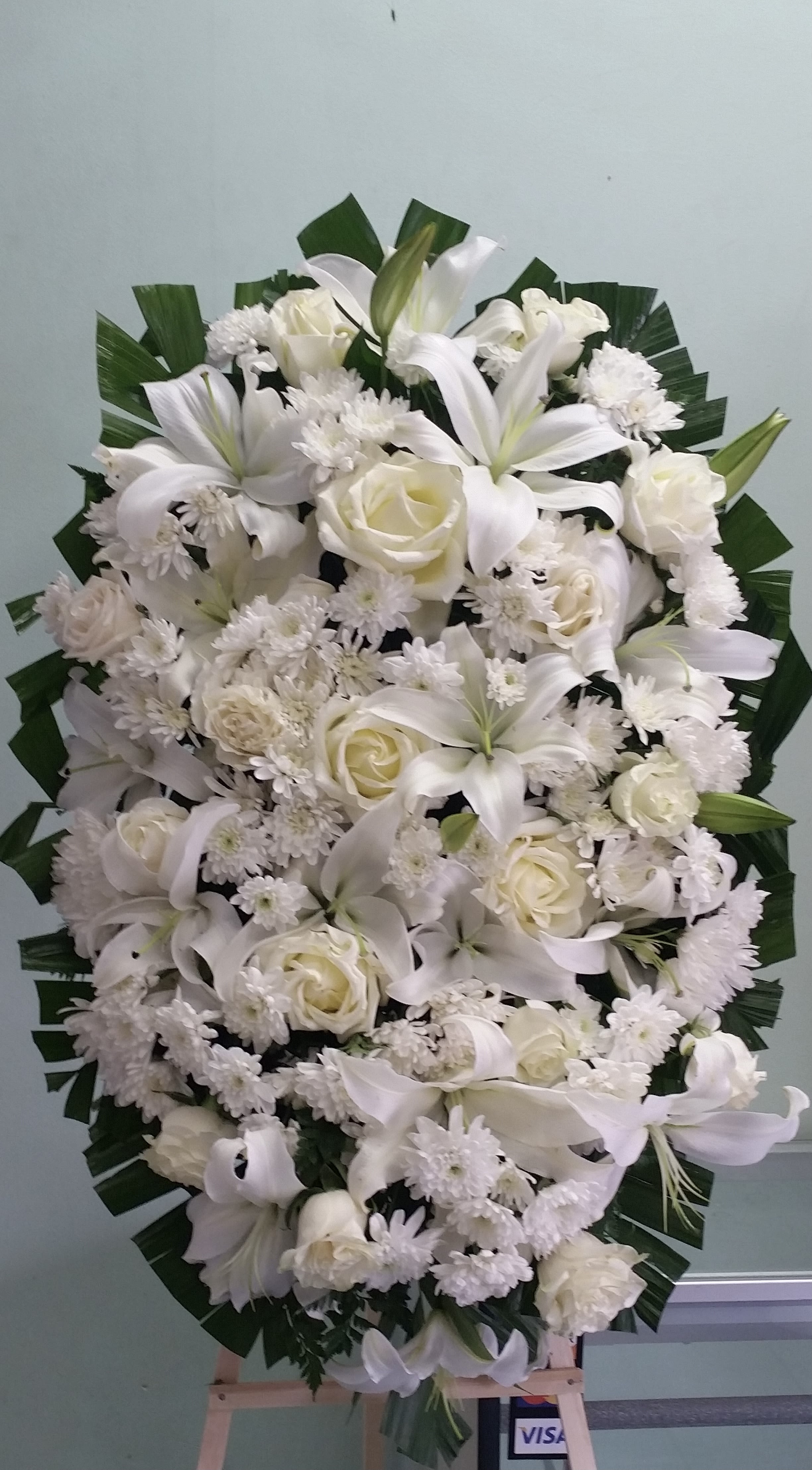 Bright Light Spray Bright Light Spray - Spray with white roses, cushion daisies, and lilies.