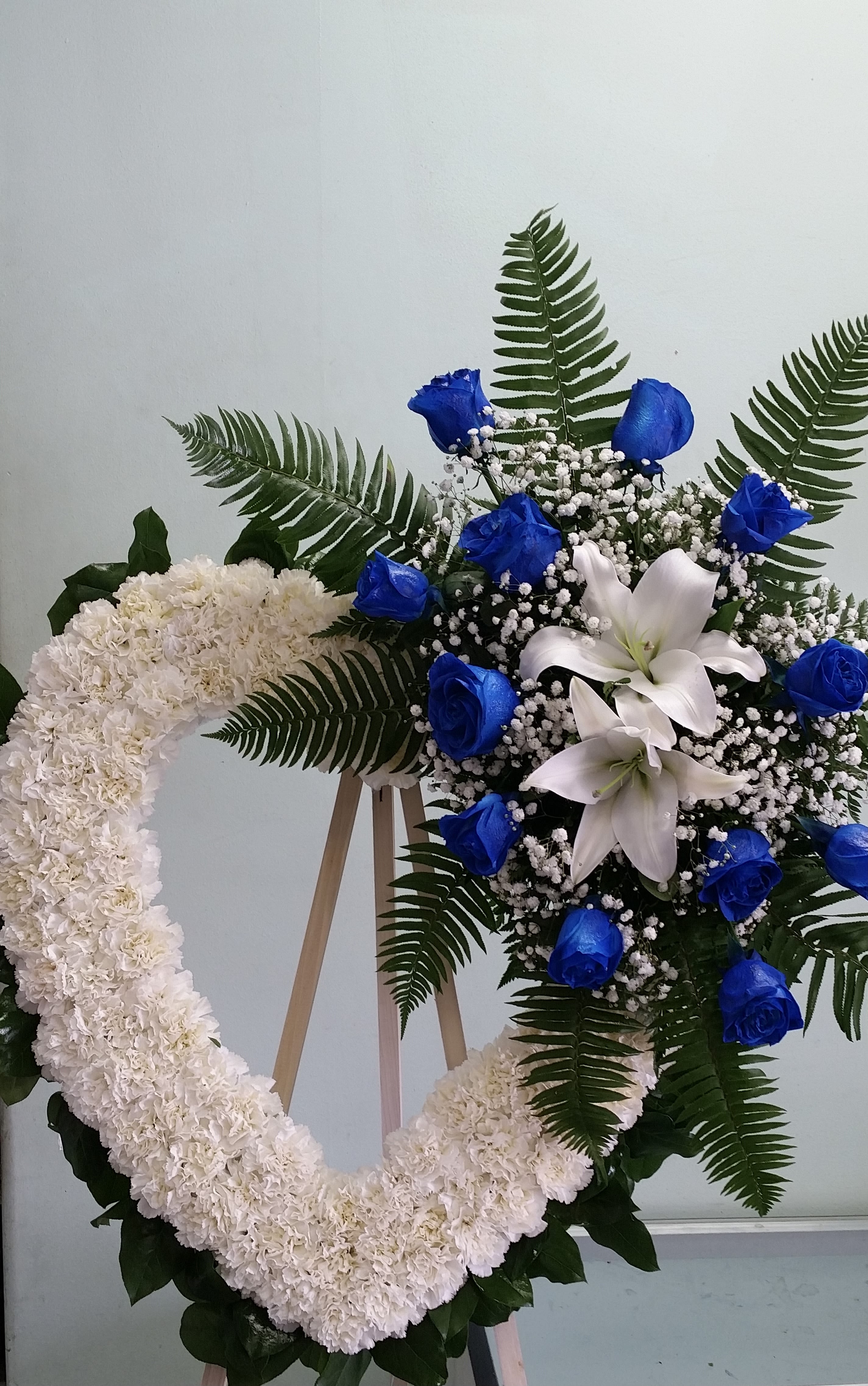 Blue Horizon Heart Blue Horizon Heart - Open heart with white carnations, white lilies, and blue roses.