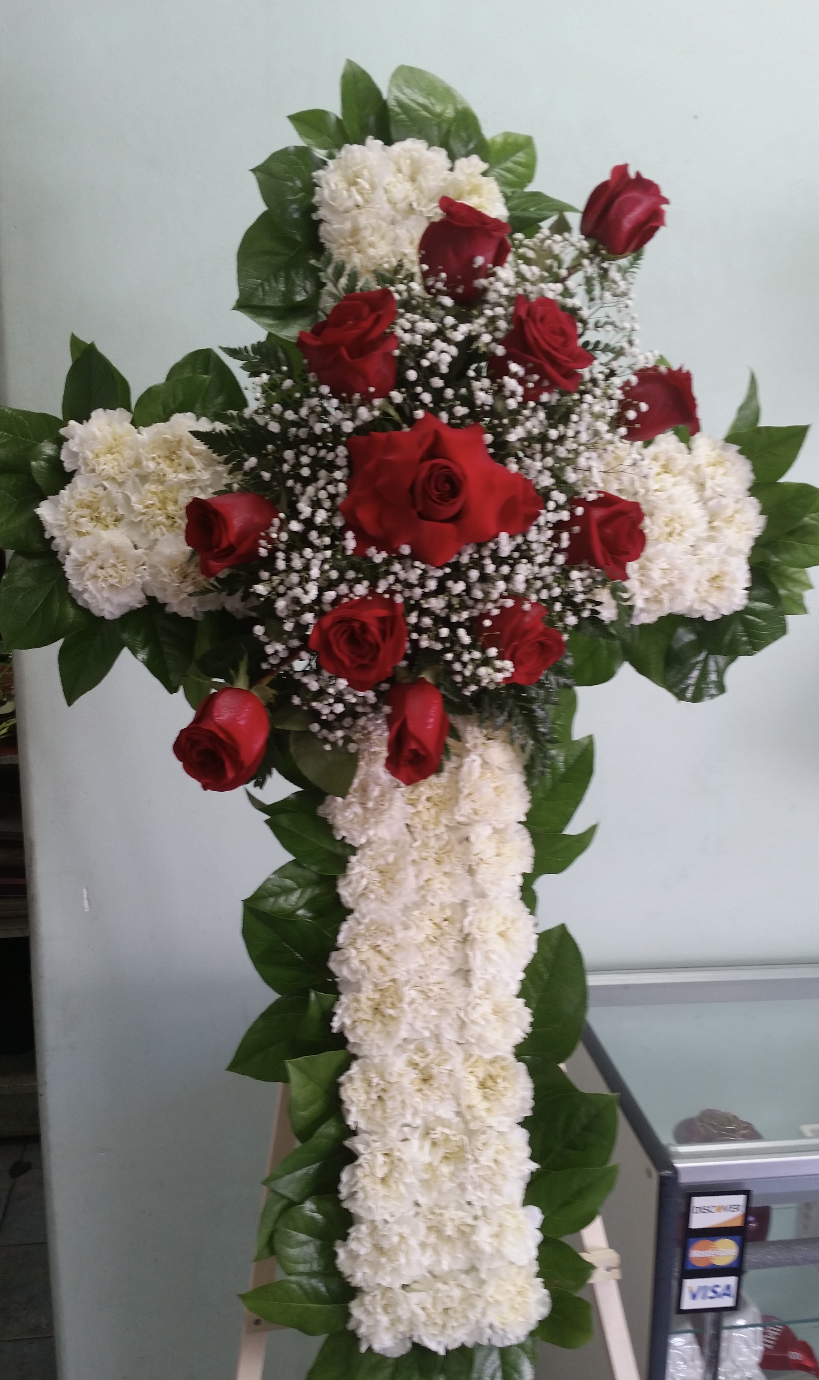 Radiant Tribute Cross Radiant Tribute Cross - Cross with white carnations and red roses.