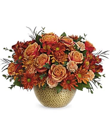 Teleflora's Vintage Gold Centerpiece - Add autumnal elegance to your fall celebrations with radiant orange roses, artfully arranged in a magnificent metal bowl with hammered gold finish . This bouquet features orange roses, red alstroemeria, miniature peach carnations, bronze cushion spray chrysanthemums, bronze daisy spray chrysanthemums, lemon leaf, parvifolia eucalyptus and red agonis. Delivered in Teleflora's Vintage Gold Bowl.