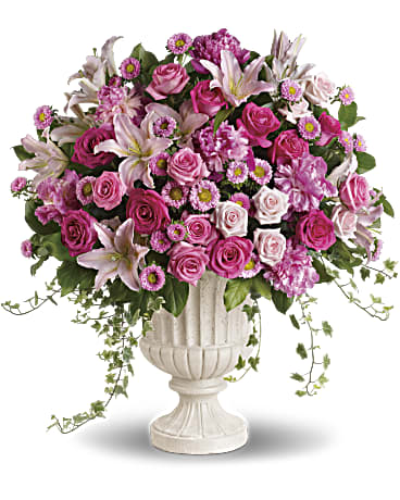 Passionate Pink Garden Arrangement Passionate Pink Garden Arrangement - Pink is romantic. Pink is honest. Pink is pretty. If pink is your choice for wedding colors then this is the perfect arrangement for you. Lots of different types of blossoms in lots of different sizes and shades of pink are arranged in a distinctive white container. If you're passionate about pink, there's no need to over-think! Light pink lilies and roses, hot pink matsumoto asters and roses, perfectly pink peonies and roses are beautifully accented with ivy and salal and delivered in a classical white urn. Orientation: All-Around