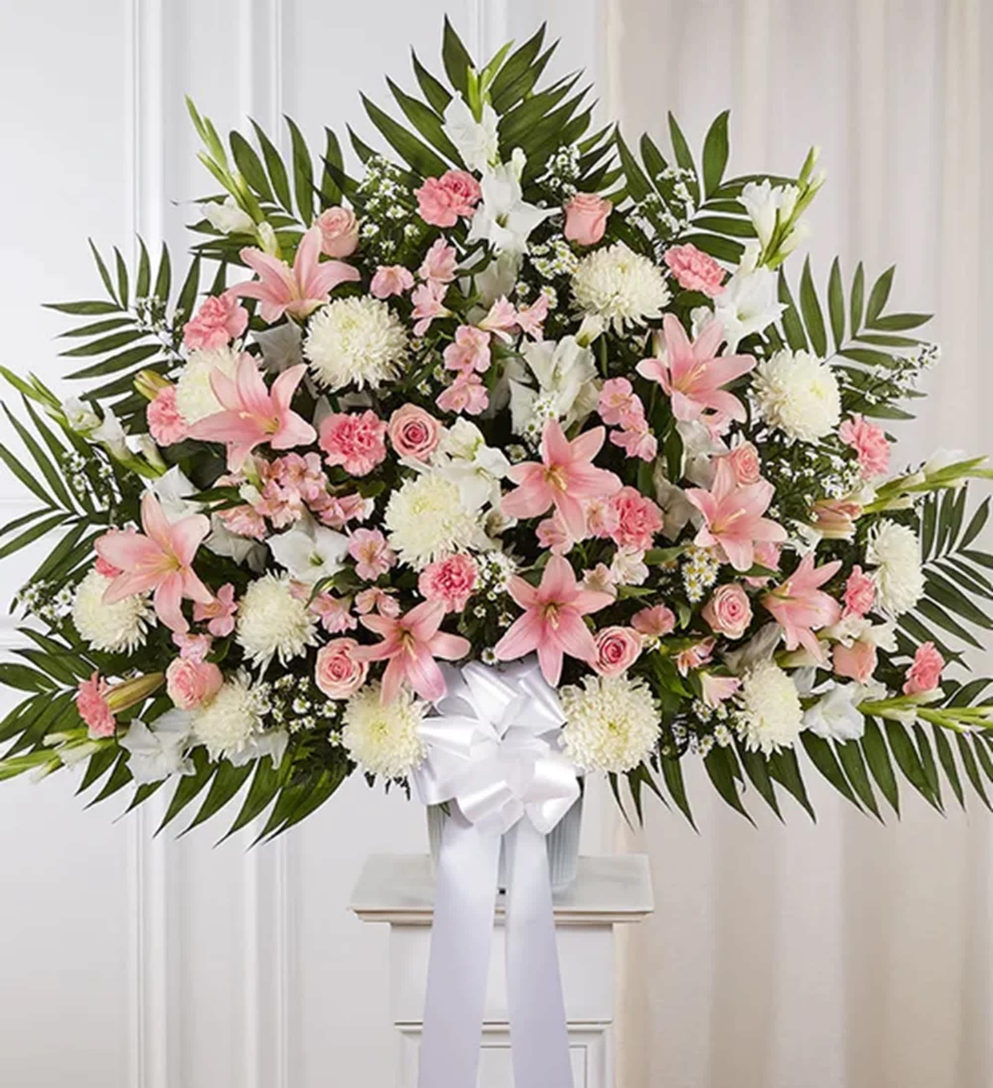 Heartfelt Sympathies - Pink and White Luxury Standing Basket  - For those who are grieving, a heartfelt gesture can mean so much. Our elegant luxury pink and white standing basket arrangement will honor the memory of a loved one in a beautiful way. Artistically designed with a medley of pink blooms, this touching expression offers comfort and support when it’s needed most. Appropriate for the funeral services or memorial service.  DETAILS One-sided standing basket arrangement with pink roses, Asiatic lilies, Peruvian lilies (alstroemeria) and carnations, white gladiola, football mums and monte casino; accented with assorted greenery and white bow.  BASKET CONTAINER INCLUDED Orientation: One-Sided Item #NF-1061  FLORIST-TO-DOOR Same day flower delivery on most orders placed online by 12 pm or 10 am on weekends PST.  BLOOM DETAILS Roses Football-mums Alstroemerias Carnations Gladiolas Asiatic Lilies Montecasino Spray Greenery  The Standard Arrangement is approx. 39&quot;H x 41&quot;W. The Deluxe Arrangement is approx. 40&quot;H x 42&quot;W. The Premium Arrangement is approx. 41&quot;H x 43&quot;W.  How to place an order? 1. You can place an order directly on this secure website OR 2. You can call in your order by dialing: (323) 262 - 9238 OR 3. You can visit our store (appointment recommended 323.262.9238)  NINFA'S FLOWERS 2405 WHITTIER BLVD. LOS ANGELES, CA. 90023