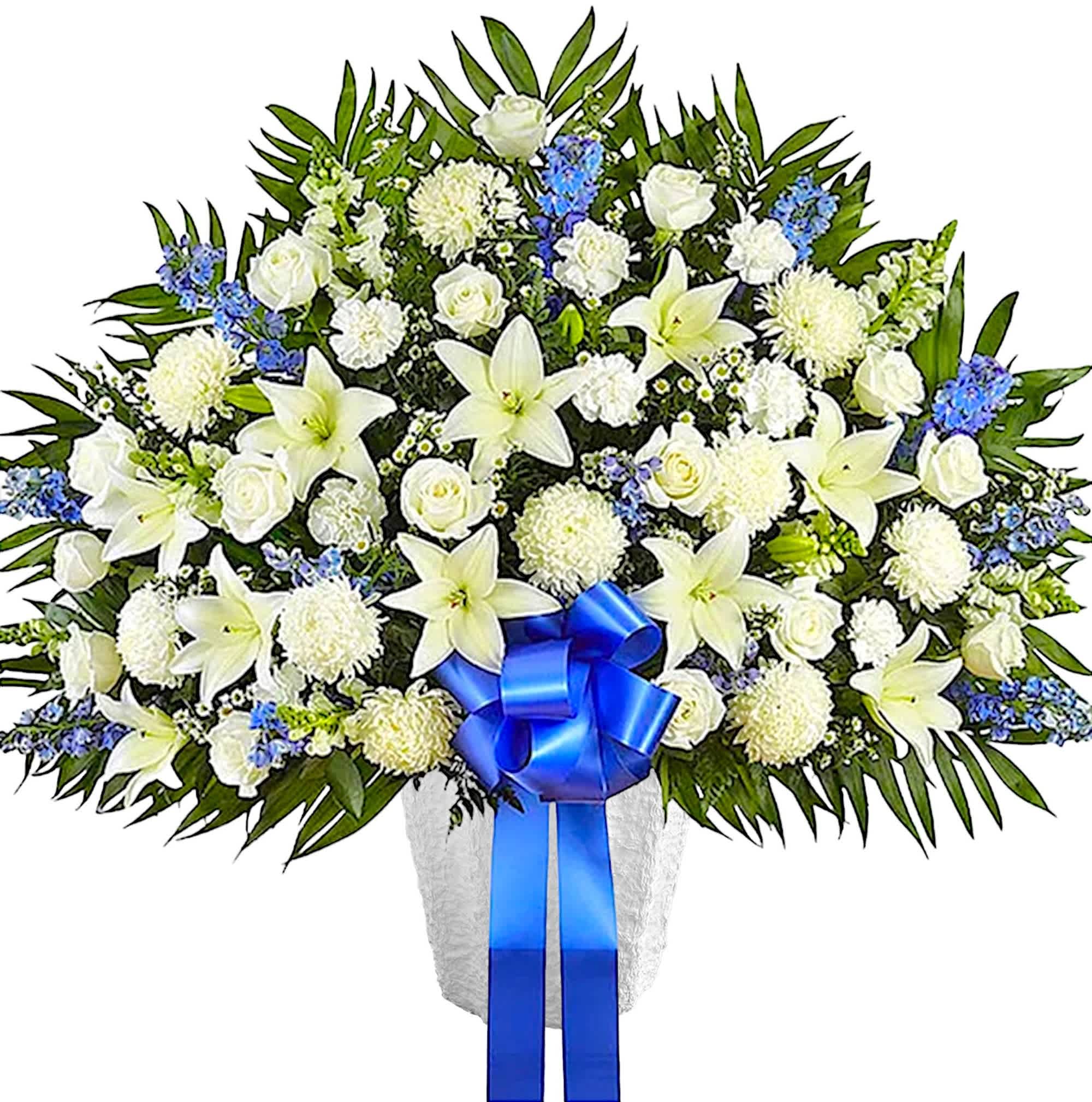 Heartfelt Sympathies - Blue and White Luxury Standing Basket - Maybe they loved the color blue…or maybe they enjoyed the calmness of the ocean under a cloudless sky. Our majestic blue and white luxury standing basket arrangement will help honor their memory in a unique and meaningful way. Artistically designed with rich blue and pristine white blooms, this floral tribute is a heartfelt expression of your deepest sympathies. Appropriate for the funeral services or memorial service.  DETAILS Standing basket arrangement with white roses, Asiatic lilies, football mums, snapdragons, carnations and monte casino; blue delphinium; accented with soft, lush greenery and blue bow.  BASKET CONTAINER INCLUDED Orientation: One-Sided Item #NF-1063  FLORIST-TO-DOOR Same day flower delivery on most orders placed online by 12 pm or 10 am on weekends PST.  BLOOM DETAILS Roses Football Chrysanthemums Snapdragon Carnations Delphinium Asiatic Lilies Montecasino Spray Greenery  The Standard Arrangement is approx. 39&quot;H x 42&quot;L. The Deluxe Arrangement is approx. 41&quot;H x 46&quot;L. The Premium Arrangement is approx. 43&quot;H x 50&quot;L.  How to place an order? 1. You can place an order directly on this secure website OR 2. You can call in your order by dialing: (323) 262 - 9238 OR 3. You can visit our store (appointment recommended 323.262.9238)  NINFA'S FLOWERS 2405 WHITTIER BLVD. LOS ANGELES, CA. 90023