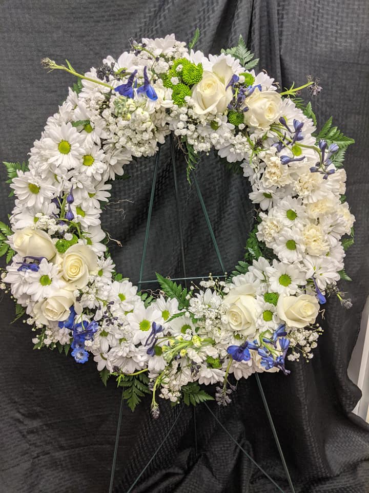 Serenity Wreath Serenity Wreath - Sympathy arrangements please call us right away for delivery to Memorials or Funeral Homes. 520-568-4600 A ring of fragrant bright white blossoms will create a serene display at any funeral or wake. This classic wreath is delivered on an easel and is a thoughtful expression of sympathy and admiration.