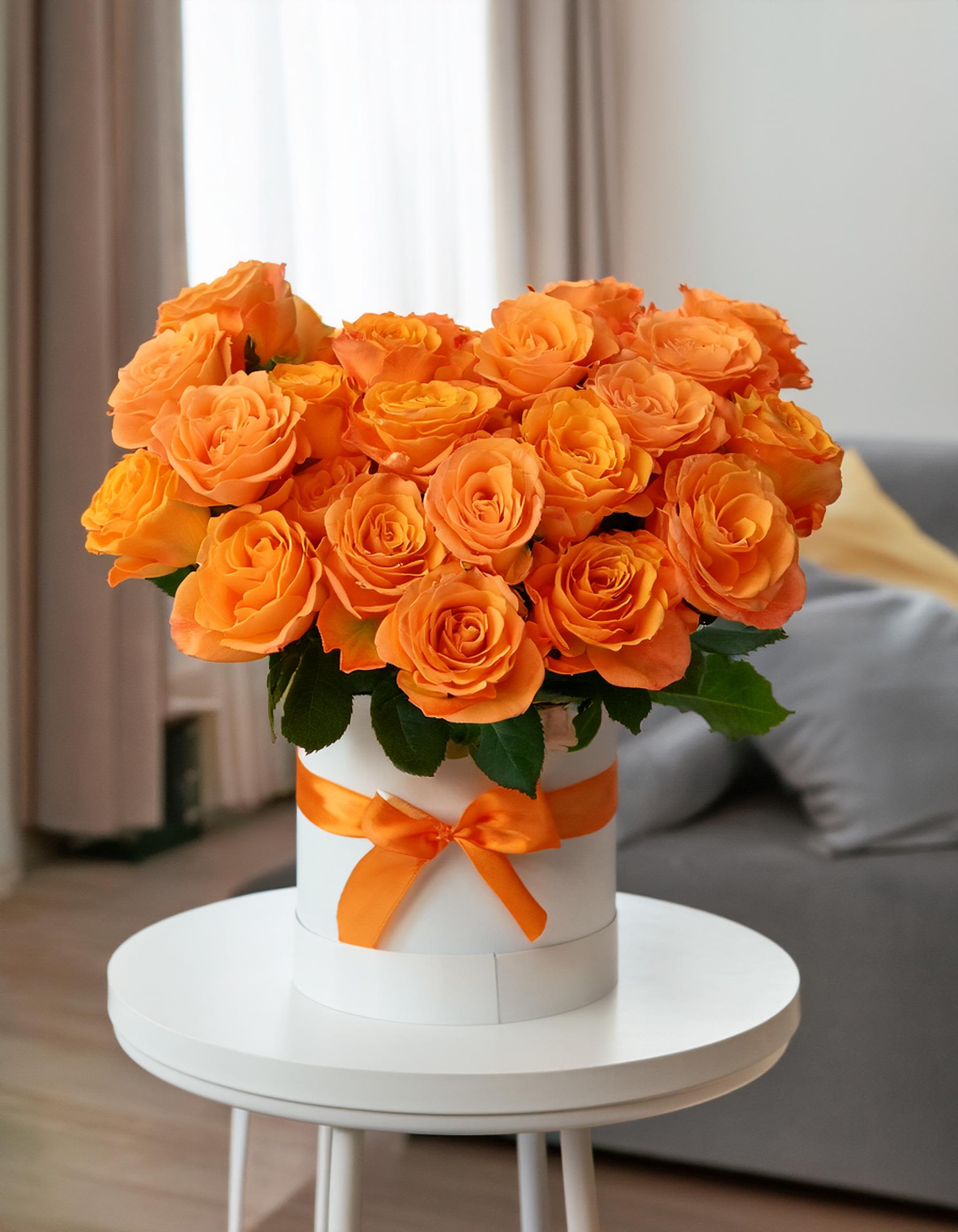 Orange Joy Orange Joy - Brighten your day with our sophisticated white hatbox featuring fresh orange roses. This stylish arrangement makes a memorable gift for your loved ones. Don’t miss out—shop today!