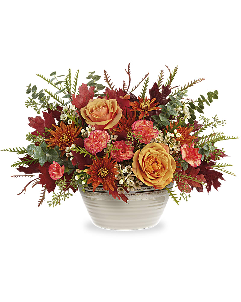 Rustic Harvest Centerpiece - Invite fall beauty to the table with this radiantly rustic rose centerpiece, presented in a classic stoneware serving bowl with gorgeous reactive glaze detail. This autumn bouquet features light orange roses, miniature orange carnations, bronze cushion spray chrysanthemums, white waxflower, spiral eucalyptus and grevillea accented with preserved oak leaves. This Rustic Harvest Centerpiece is delivered in Teleflora's Rustic Harvest Bowl.