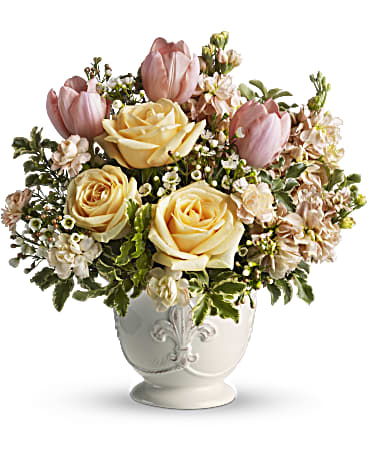 Teleflora's Peaches and Dreams Teleflora's Peaches and Dreams - Just peachy! This soft, feminine bouquet of peach-colored spring flowers is presented in a French country ceramic pot with fleur-de-lis motif. The country style floral arrangement is a pretty way to send your best wishes. Peach colored flowers - roses, carnations, tulips and stock - are gathered with delicate white waxflower and variegated pittosporum into Teleflora's French country ceramic pot. Orientation: All-Around
