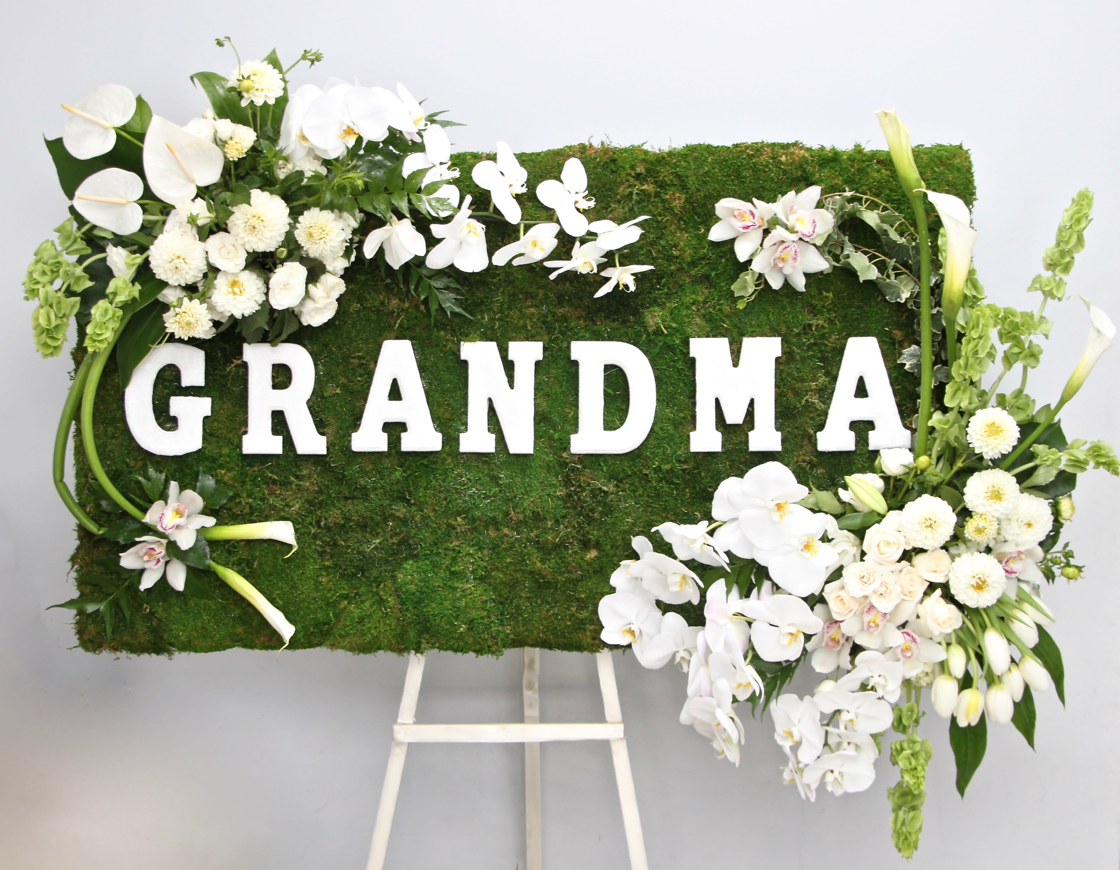 Full Moss Frame  - Covered in moss, this frame includes orchids, tulips, and season flowers. It also features a custom letter accent of your choice.   Standard: 2'x3'  Deluxe: 3'x3'  Premium: 4'x3'