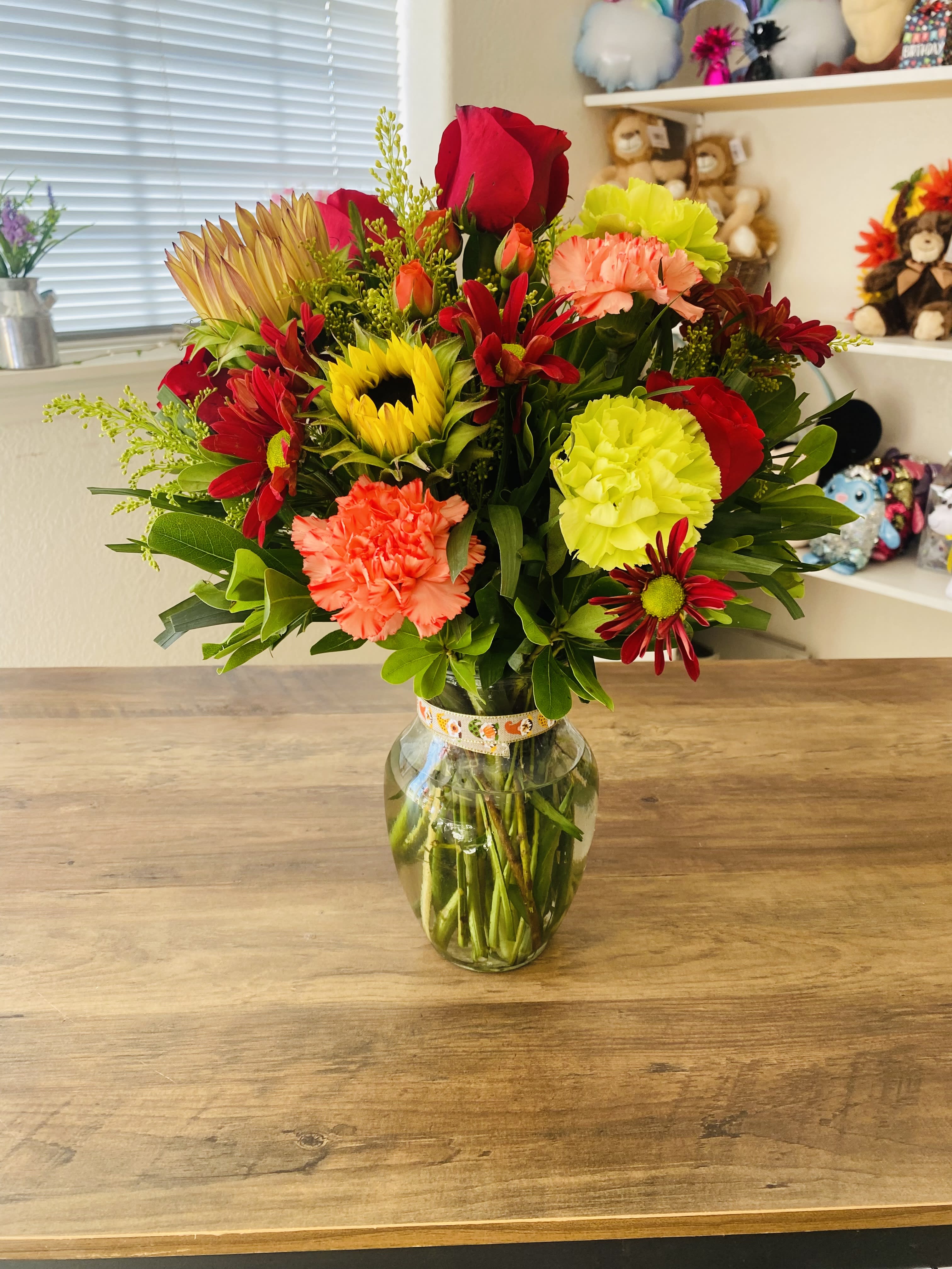 Autumn Delite Autumn Delite - An arrangement with an array of autumn colors arranged in a rose a vase that will surely delight that special person in your life!