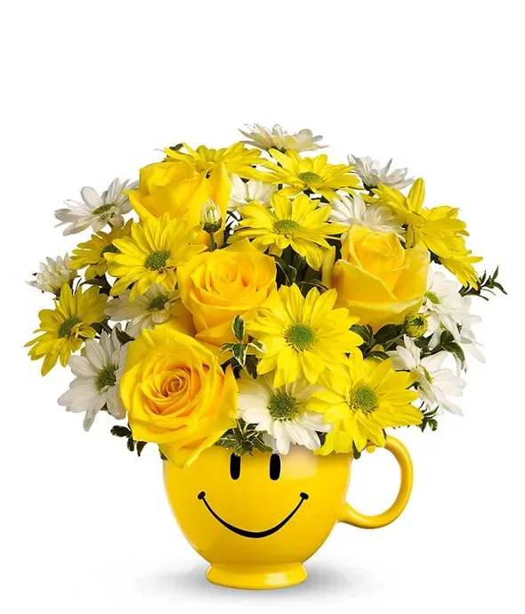 Happy Face Mug - Put a smile on their face with this cute arrangement designed with roses and daisies in a keepsake mug.