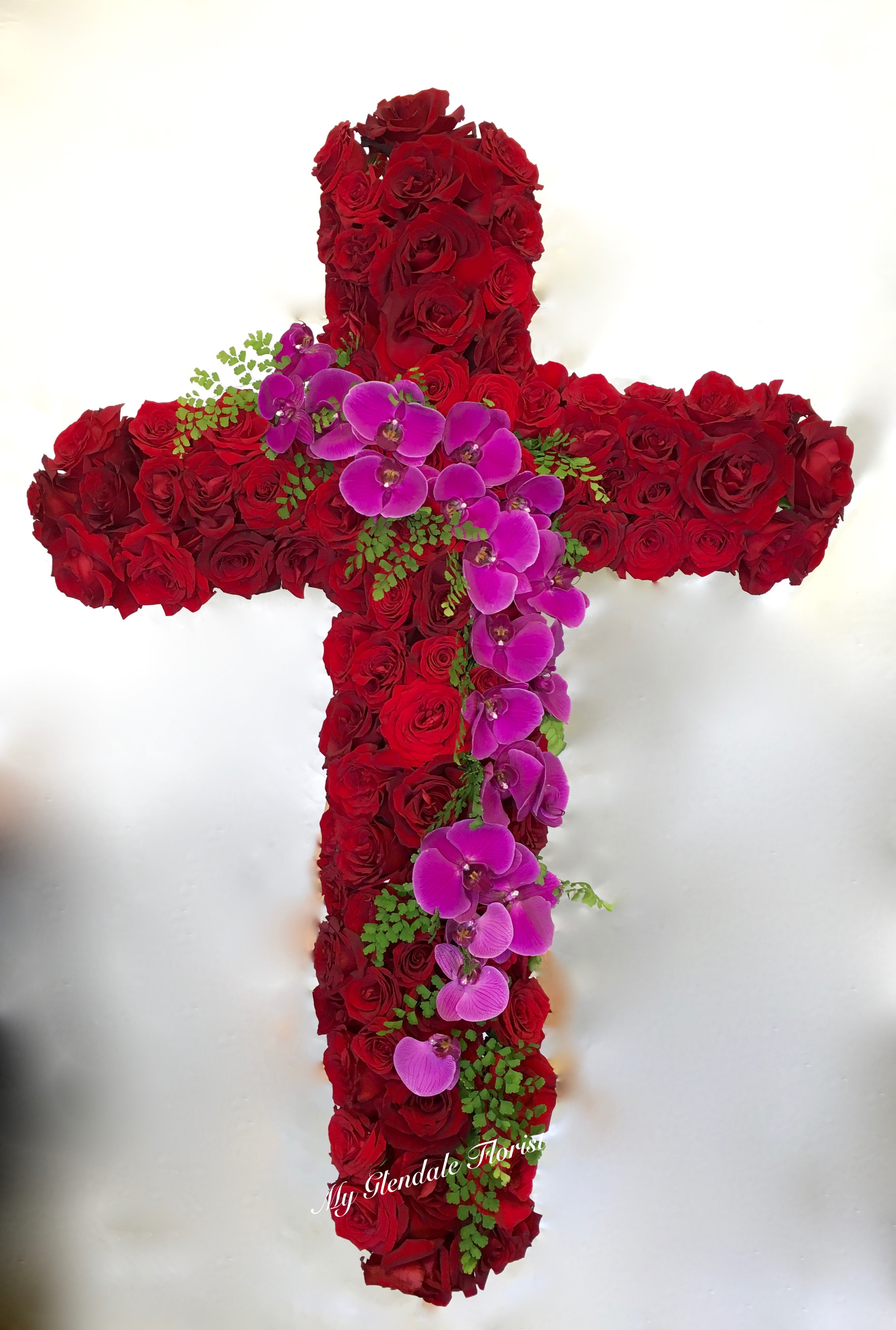 Red Cross  - This large arrangement features a classic combination of roses and orchids.     We include easel, printed banner and delivery (some fees may apply). An additional banner can be added for $15.    Standard size is 30'', deluxe is 36'', and premium is 42''.