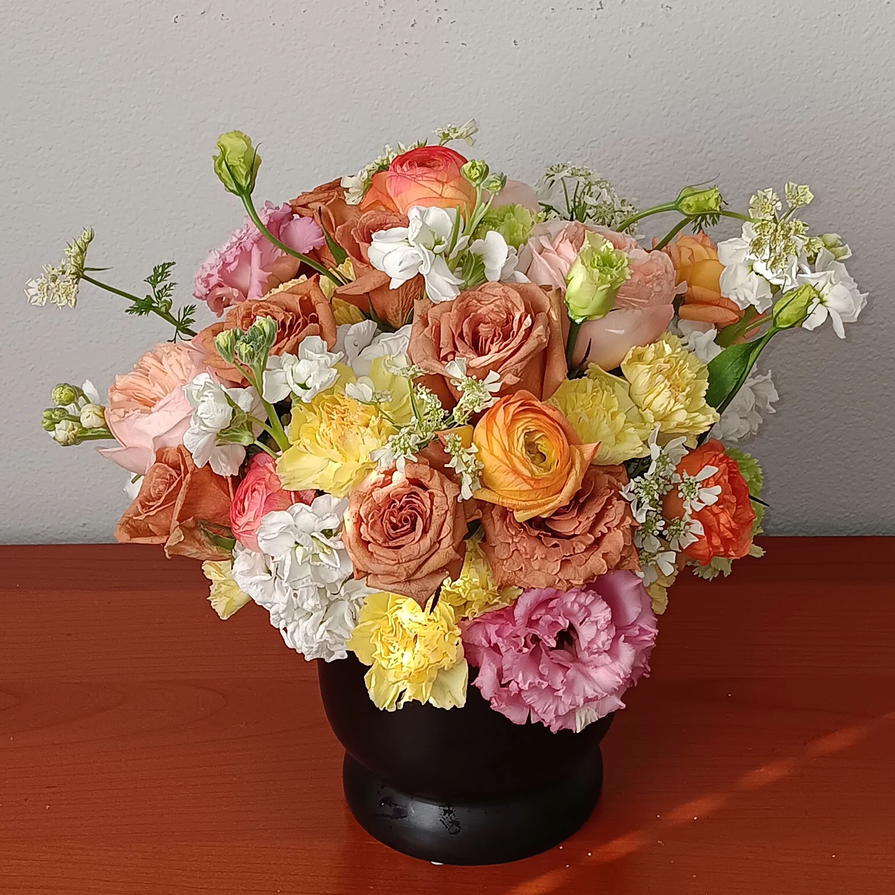 Mid Mod Brights Bouquet - Talk about a bright idea! This cheerful bouquet  brings joy to any occasion--especially since the lucky recipient gets to keep the chic mid-century ceramic planter!  Orientation: All-Around  SUBSTITUTION POLICY – Always deliver the freshest flowers! Please note the bouquet pictured reflects our original design.  If the exact flowers or container in this arrangement are not available, our local florists will create a beautiful bouquet with the freshest available flowers