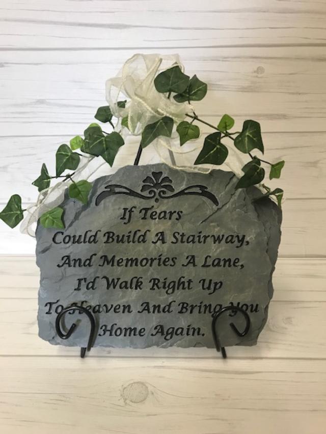 Sympathy Stepping Stones - Stepping stone comes on an easel decorated with silk ivy and a bow. Verses or sayings can vary, designer will choose or you may call for availability. Stones can be added to a dish garden or placed in an arrangement of flowers for an additional charge. STONES AND FLOWERS MAY VARY DUE TO AVAILABILITY.