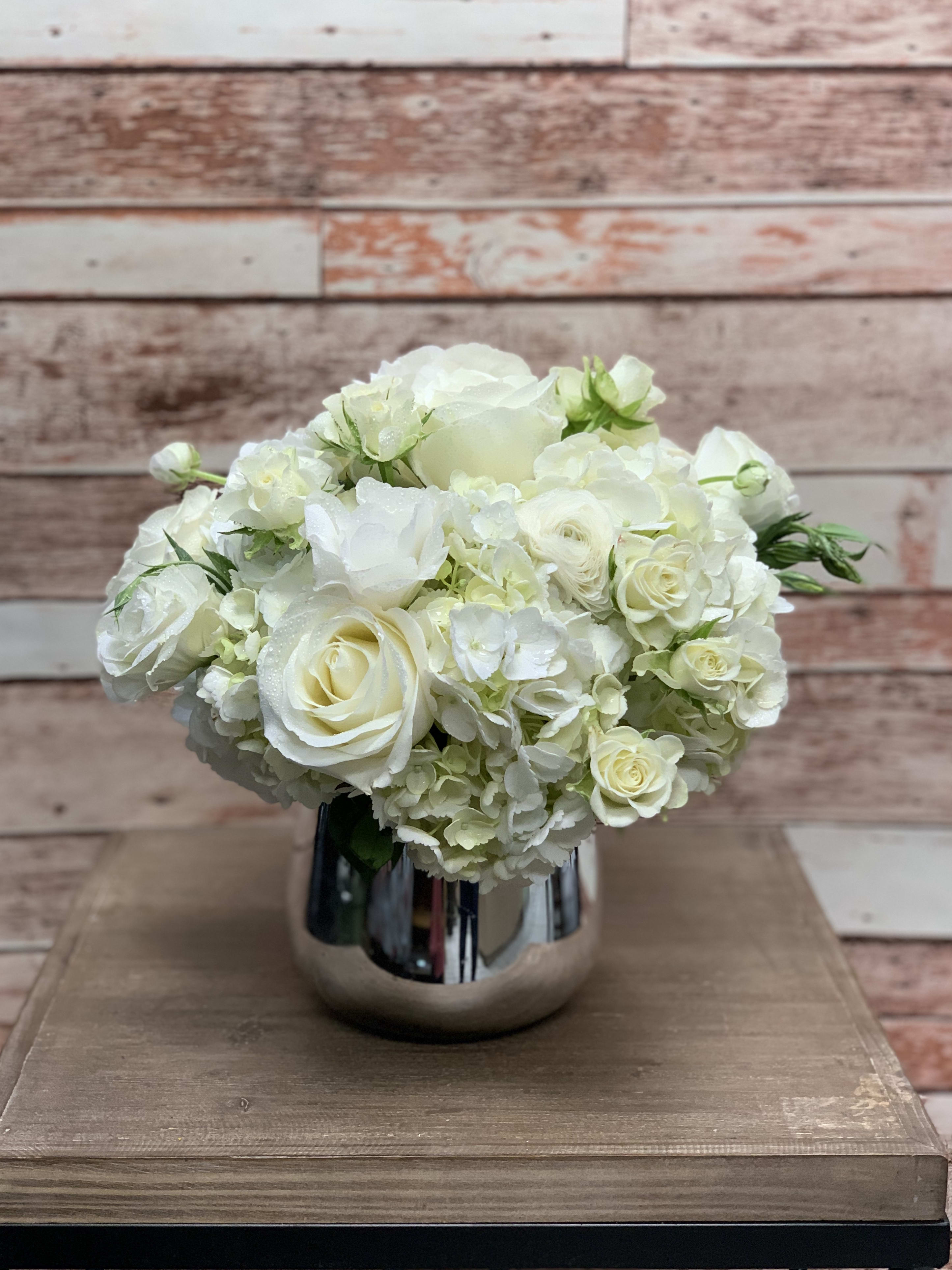 Mirrored Mirrored - Elegant white flowers make for a timeless arrangement. Arranged in a mirrored vessel