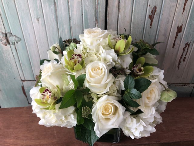 Elegant Whites Elegant Whites - White hydrangea, White roses, green mini cymbidum and seasonal greenery in a 5x5 ti leaf lined glass cube section, Due to covid related shortages we may not be able to match the arrangement exactly. Containers or flowers may substituted at designers discretion. Thank you for your understanding.