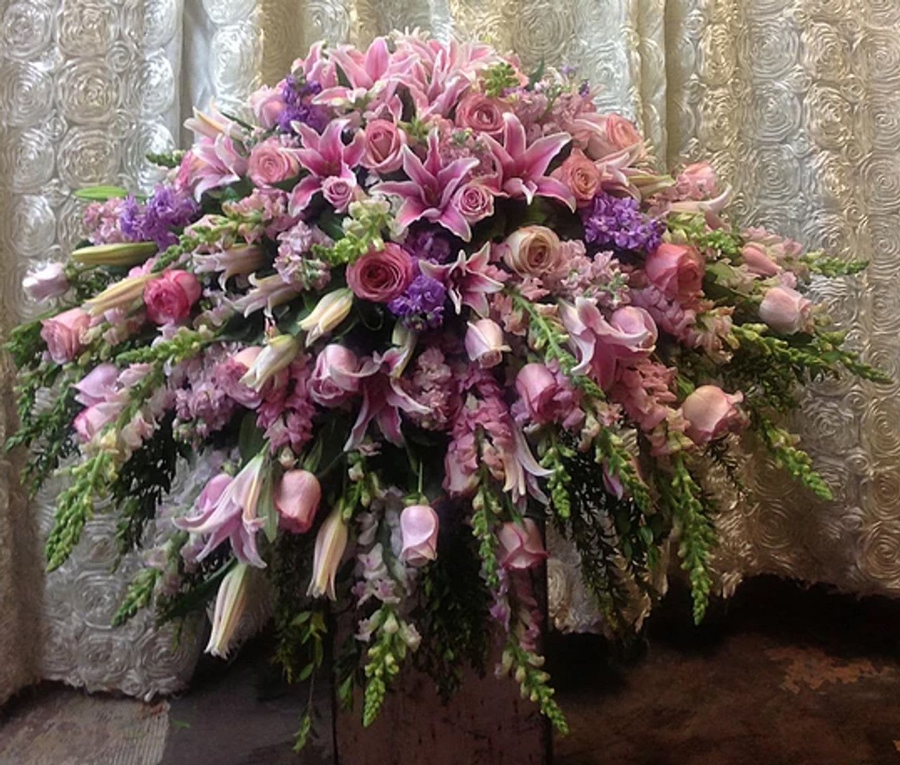 Mauve Casket Cover - Beautiful mauve colored casket spray made with seasonal flowers.
