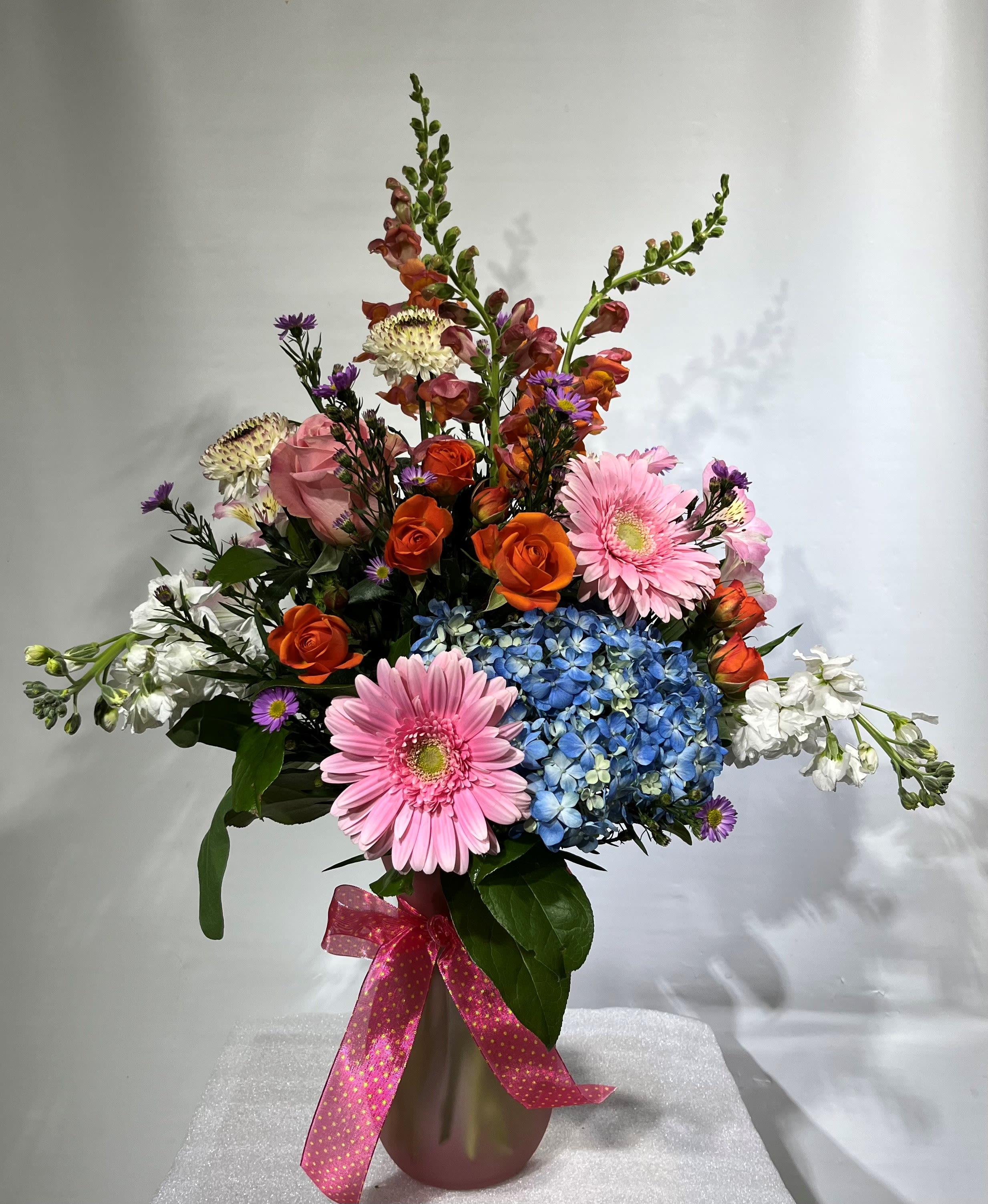 Mixing Blooms Mixing Blooms - Our designers' will choose the best bright blooms to enjoy while celebrating the best moments in life. Sure to contain a variety of flowers.