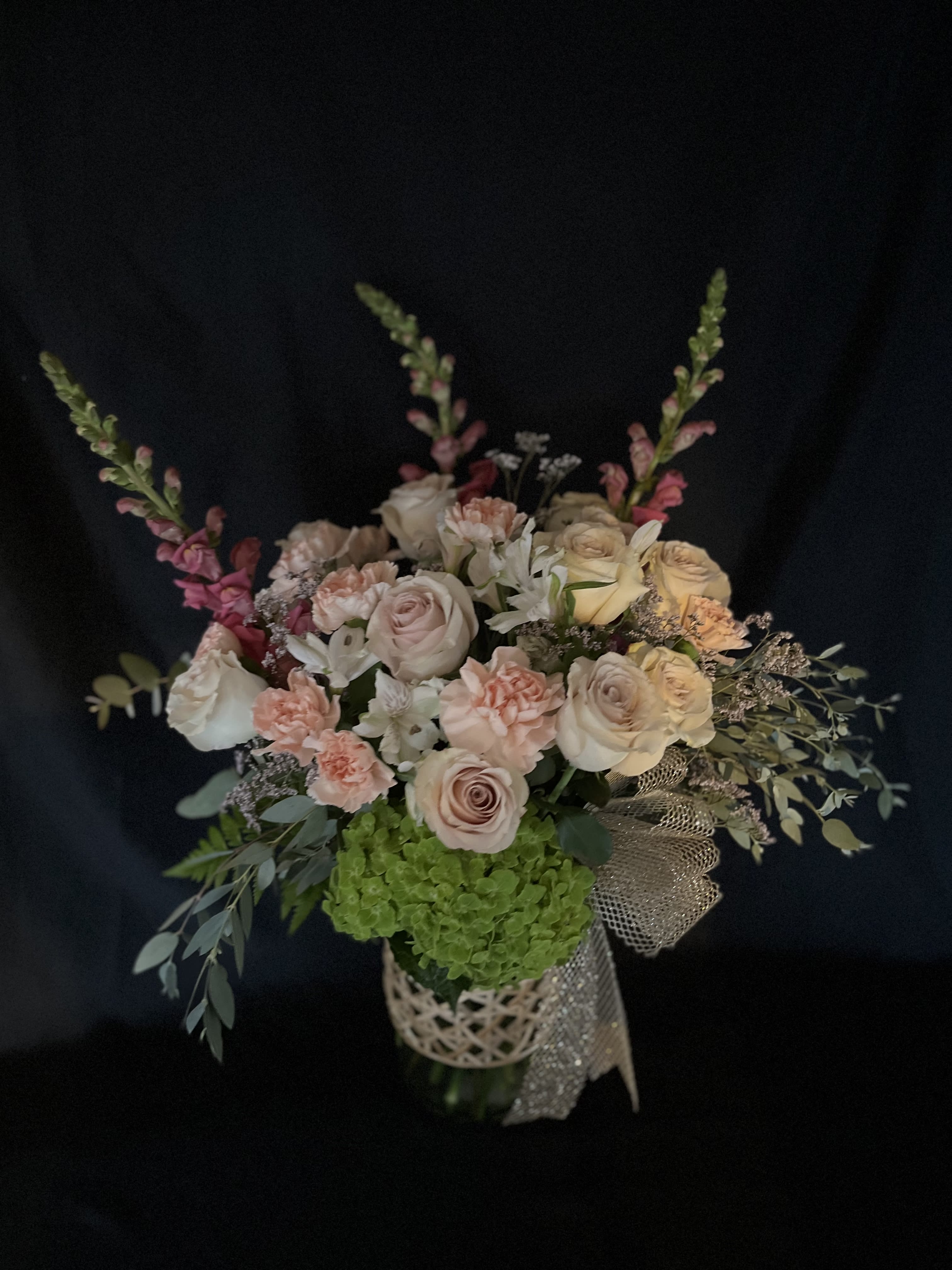 Tender Love, and Care bouquet - Fluffy 12 dozen ivory/pink roses, peach colored carnations, green hydrangeas, pink snap dragons, with eucalyptus, and limonium in a tall cylindar clear vase.  