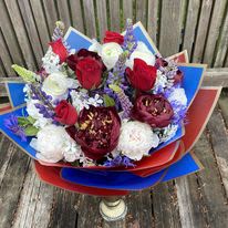 for my Hero  - An artistic and bright arrangement is a pleaser and interesting as it is impressive. Blue, Red and White is an architectural design give this arrangement its unique appeal.  Because of Seasonal flower peonies will not be available on winter and late summer, we will sub with other flower that match the color, with equal value or higher.  Wrap or Vase same price  APPROXIMATE DIMENSIONS       12&quot;W X 18&quot;H Standard                                                            14&quot;W X 22&quot;H Deluxe                                                           16&quot;W X 25&quot;H   Premium  