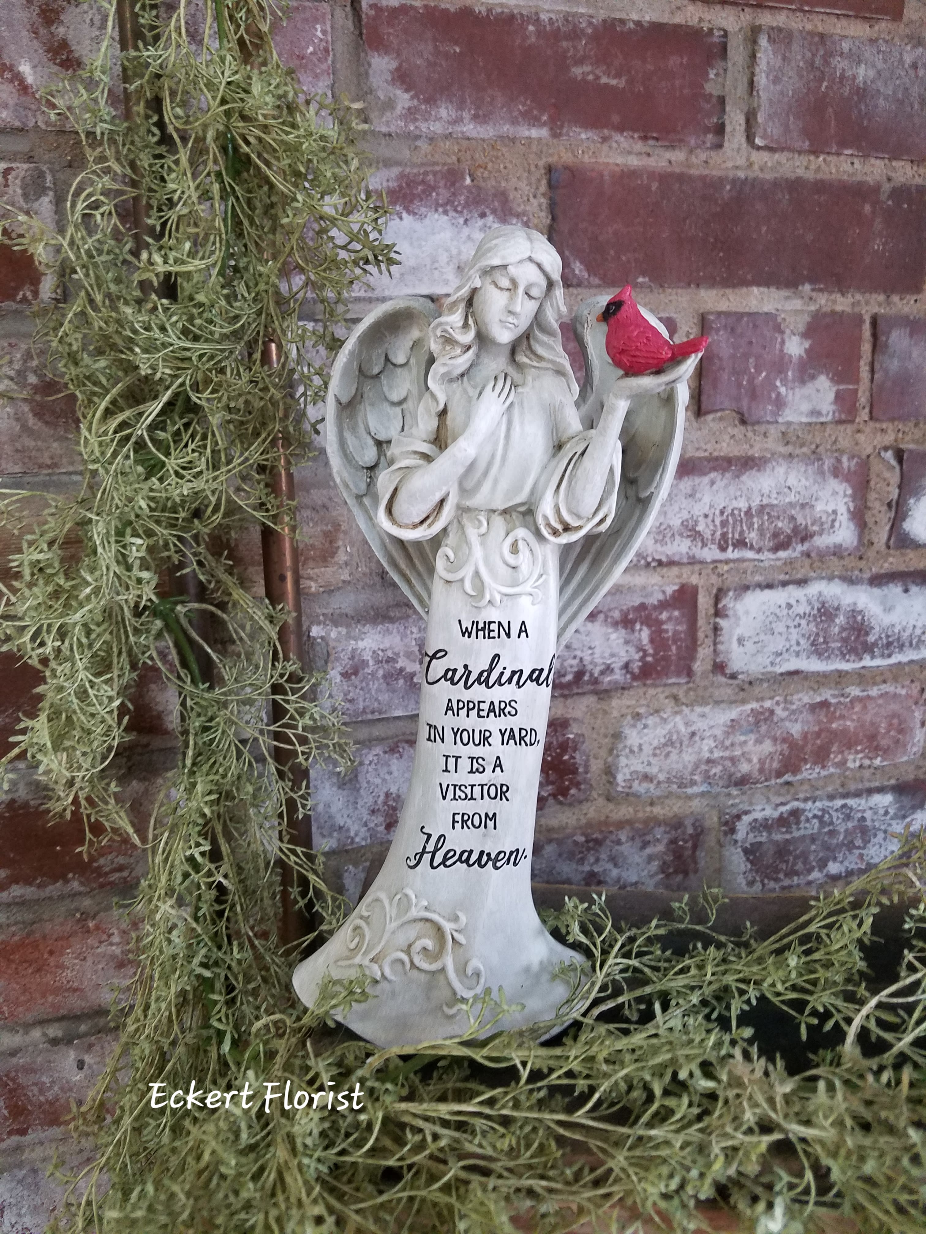 Eckert Florist's "When A Cardinal Appears..." Angel *LOCAL DELIVERY ONLY Eckert Florist's "When A Cardinal Appears..." Angel *LOCAL DELIVERY ONLY - Resin angel measures approx. 4.5" W X 10.25" H Sentiment: When a cardinal appears in your yard, it is a visitor from Heaven. Can be added to a green plant or fresh arrangement. See Deluxe or Premium upgrades.