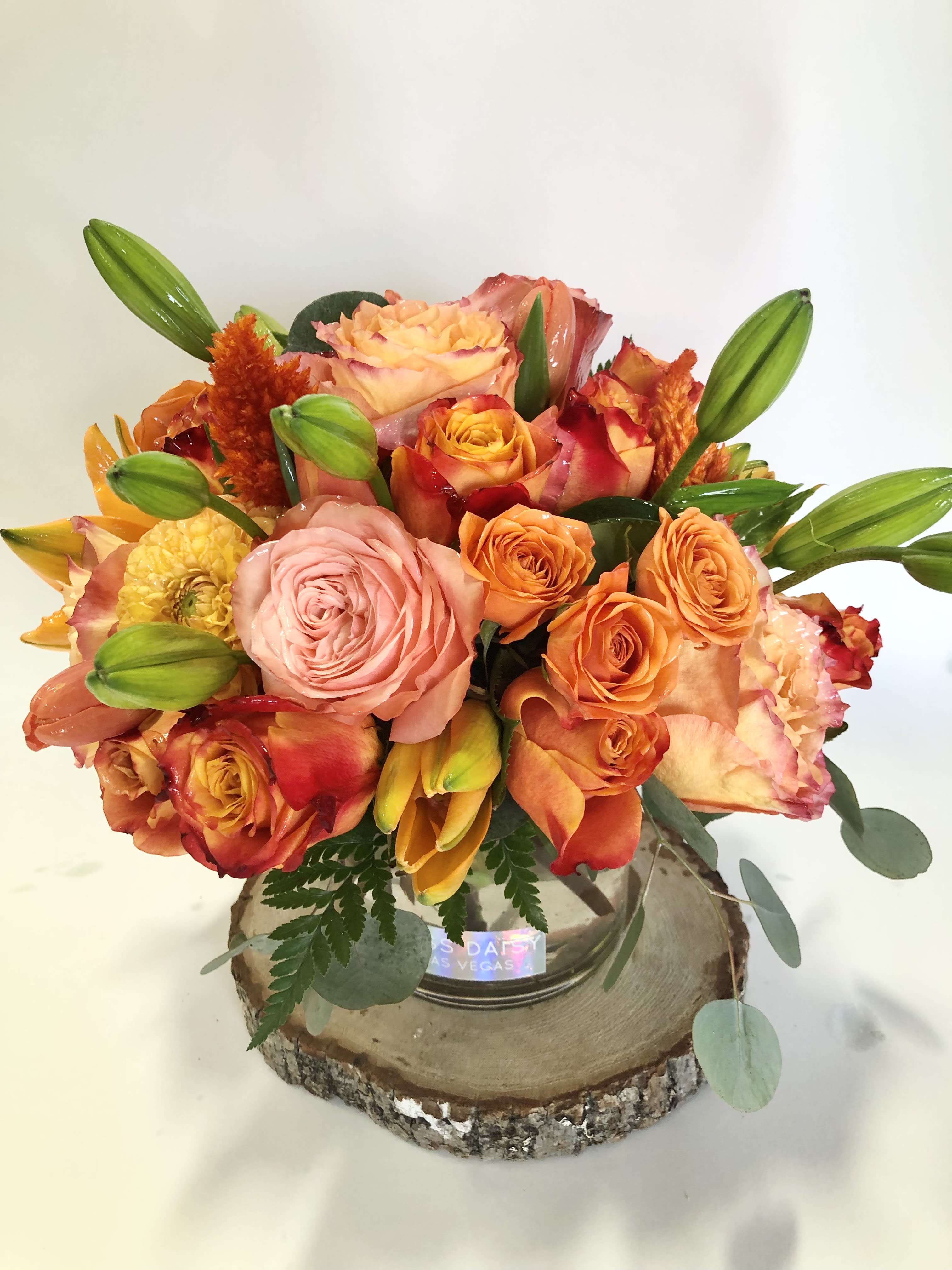 Cider House Blooms - Vibrant and festive blooms in fall tones and textures.  Florals may include: roses, lilies, spray roses, celosia, and other seasonal premium blooms.  It's possible that some days we may not have the exact flowers depending on the season, or exact container specified on the arrangement's description. When this is the case, our bouquets are made with flower substitutions or delivered in a different vase than expected by using substitutions of an equal or higher value. If you'd prefer no substitutions, please send an email or call us after placing your order. Please give us at least three days notice if you're looking for an arrangement with no substitutions.