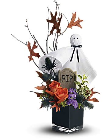 Ghostly Gardens Ghostly Gardens - Boo! A googly-eyed ghost guards a graveyard garden in this fun Halloween floral decoration. It's a whimsical way to send Halloween greetings to a special kid, or add spooky fun to your own home or office! A spooky black cube vase presents orange roses, blue eryngium, purple statice and pitta negra below a Halloween scene featuring a branch of birch, red oak leaves and a googly-eyed ghost.