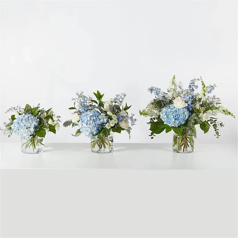 Coastal Blossom  - Open the shutters to the ocean breeze through the blue hydrangea, white alstroemeria and roses with chrysanths