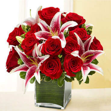 Red Rose And Lily Cube - Red roses and pink/white stargazer lilies in a cube vase make a stunning compact arrangement perfect for desk or table.