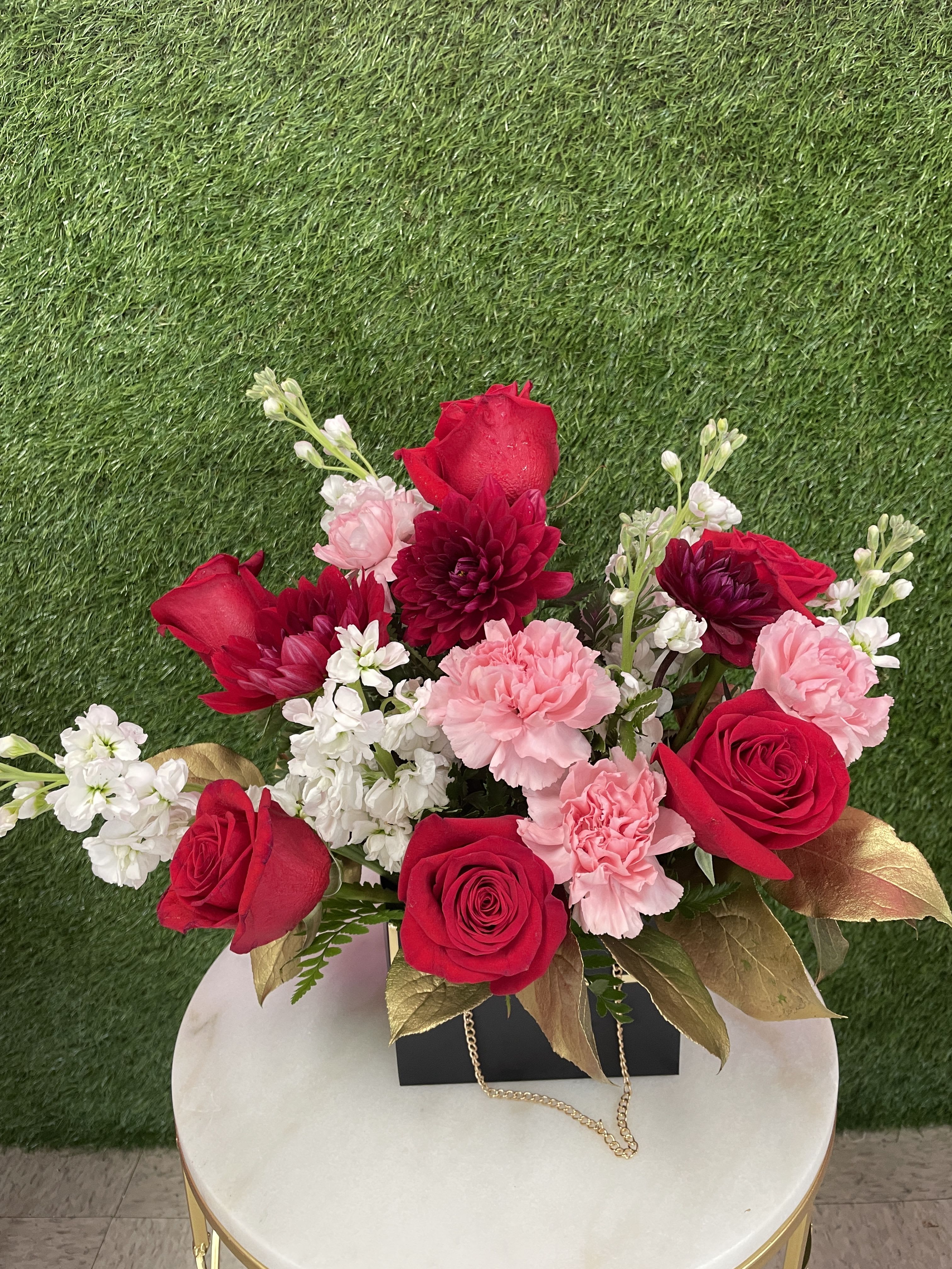 Petite Purse Bouquet - Pink, white, and red flowers mixed in a small reusable decorative purse. Color and style of purse will vary depending on what is in stock. 