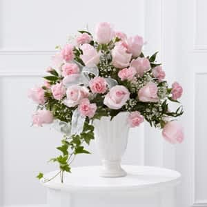 The FTD Deepest Sympathy Arrangement The FTD Deepest Sympathy Arrangement - The FTD® Deepest Sympathy™ Arrangement is a wondrous presentation of grace and elegance to honor the life of the deceased. Pale pink roses and pink carnations are offset by baby's breath variegated ivy lush greens and a white sheer ribbon gorgeously arranged in a designer white ceramic pedestal vase to create a lovely way to express your warmest sentiments offering comfort and peace with each blushing bloom.