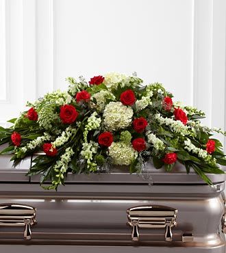Sincerity Casket Spray - The Sincerity Casket Spray is a wondrous presentation of fresh color and beauty. Rich red roses and carnations are eye-catching and elegant in an arrangement of white hydrangea, larkspur, snapdragons, Queen Annes Lace and assorted lush greens to create a lovely display meant to bedeck the top of their casket, bringing comfort and peace to those grieving the loss of the departed.