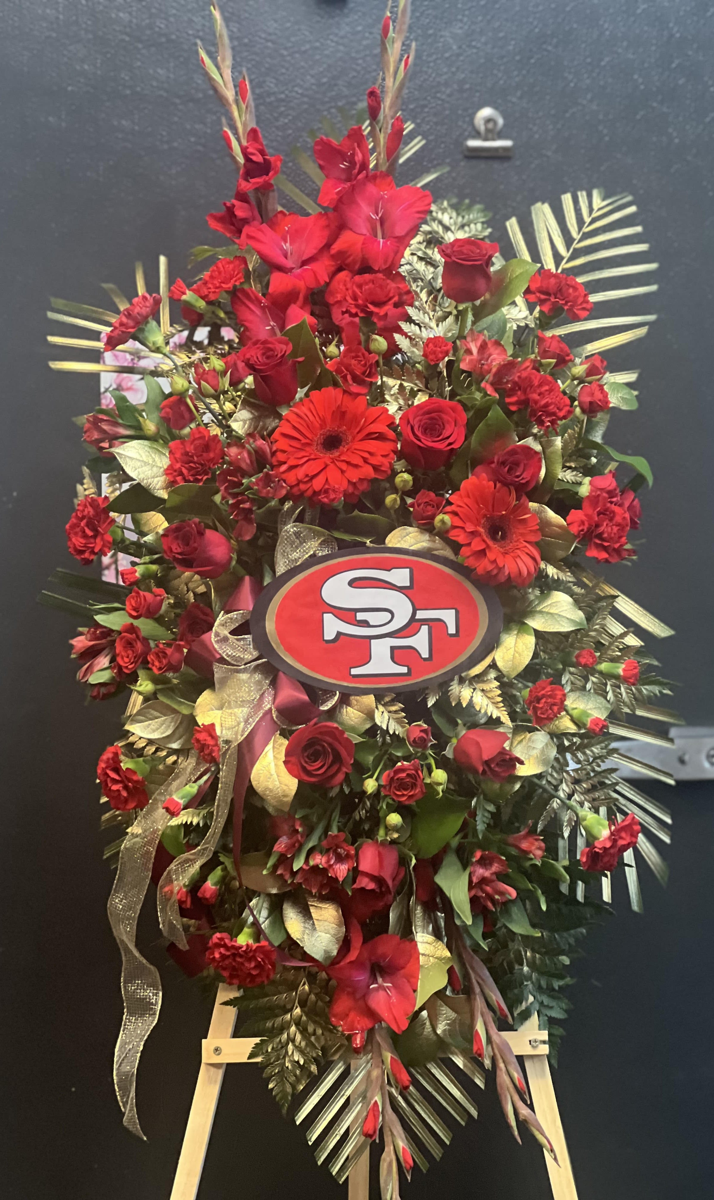 SF standing Spray SF standing Spray - Gold and Red standing spray with a SF logo in the center.