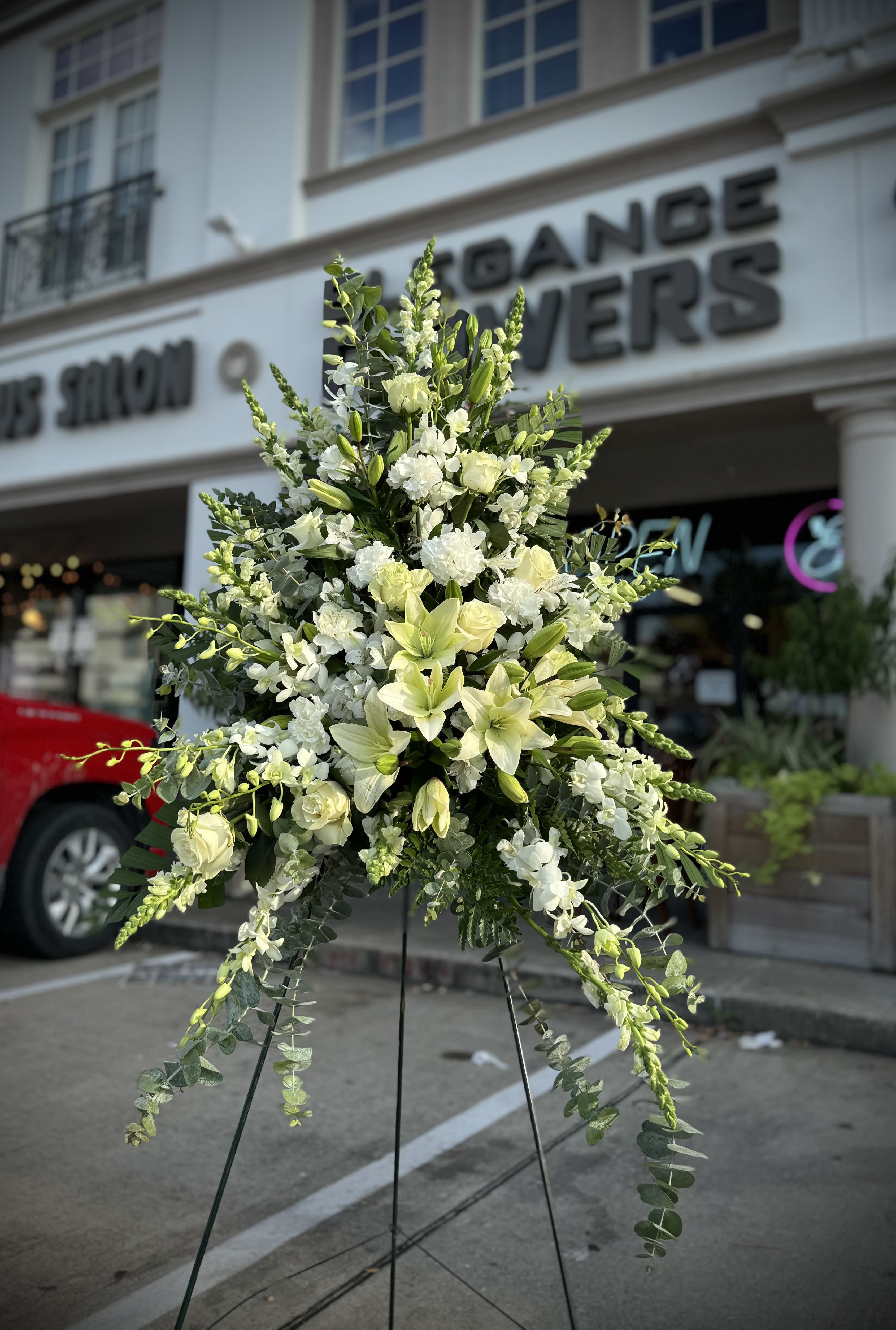 Snowfall tribute Snowfall tribute - A standings flower arrangement for a funeral service is a heartfelt tribute designed to honor and celebrate the life of the deceased. These arrangements are typically displayed on an easel or stand, making them highly visible and a central part of the memorial decor.