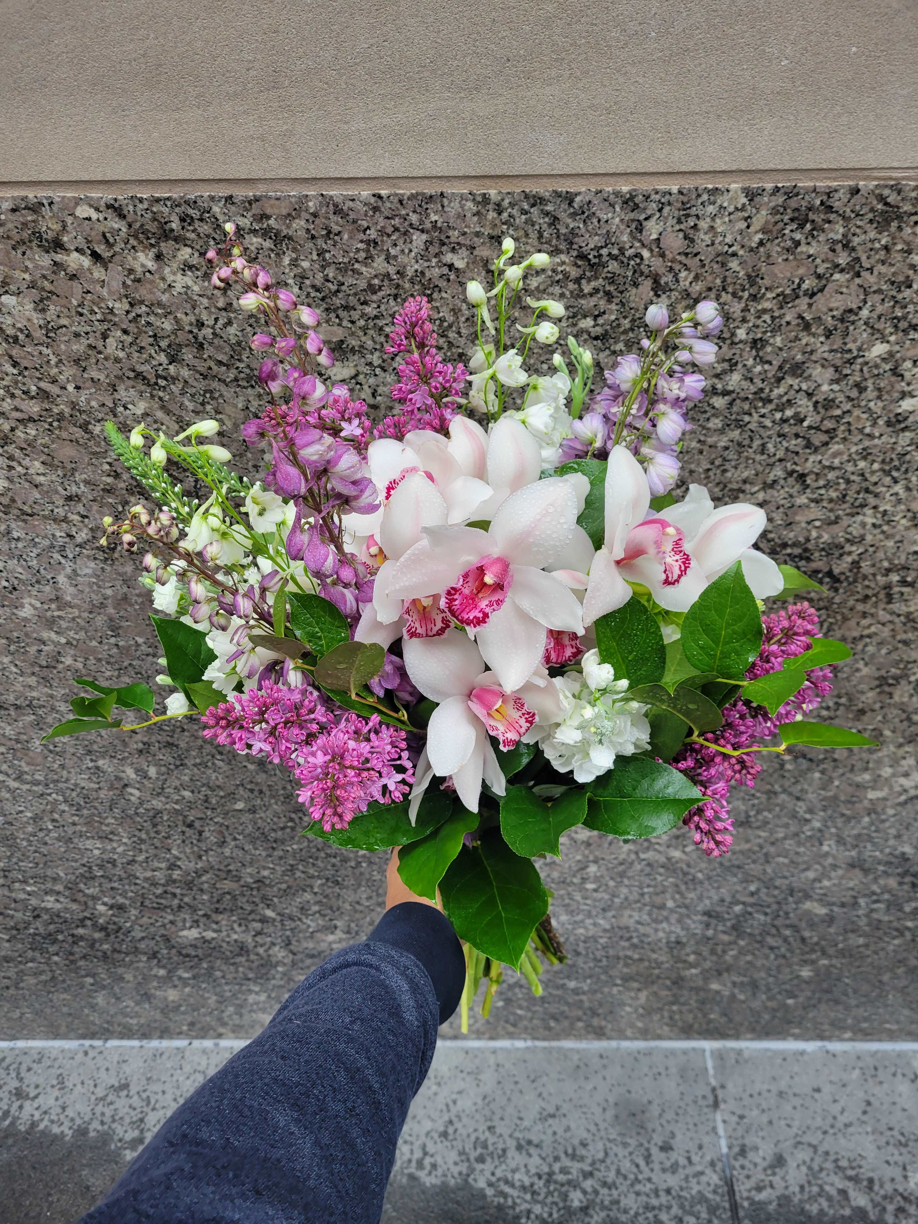 Lavender Lace - Lavender Lace Bouquet: Featuring white cymbidium orchids, hydrangeas, lilac, and stock, this arrangement embodies timeless elegance and delicate charm, perfect for any occasion.