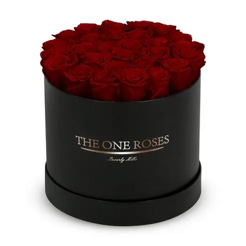 Round Flat | Classic Black Box burgundy Round Flat | Classic Black Box burgundy - The "runway round collection" consists of unique, real preserved roses in classic round handcrafted luxury soft touch box with a top. About 25-30 stems of the one long lasting (med size) preserved roses.  Durability: approx. 1-3 years.  Our roses, which are carefully sourced from the highest quality gardens in Ecuador, are made to represent the eternal yet ephemeral nature of Love itself. Our Roses are specially customized with essential oils to increase the fragrance.  Product Care: DO NOT Water the roses! AVOID direct exposure to sunlight. Keep the arrangement in a room-temperature environment. If dust collects after a few months, remove it lightly using a duster. DO NOT place anything onto the roses as they can crush and damage the roses. DO NOT remove the roses from the box; they are secure and happy there. DO NOT allow roses to have direct contact with light colored fabric or surfaces, as staining may occur. The lid is meant to stay on the side or bottom of the box. Be mindful when carrying the arrangement: it's a very delicate product!