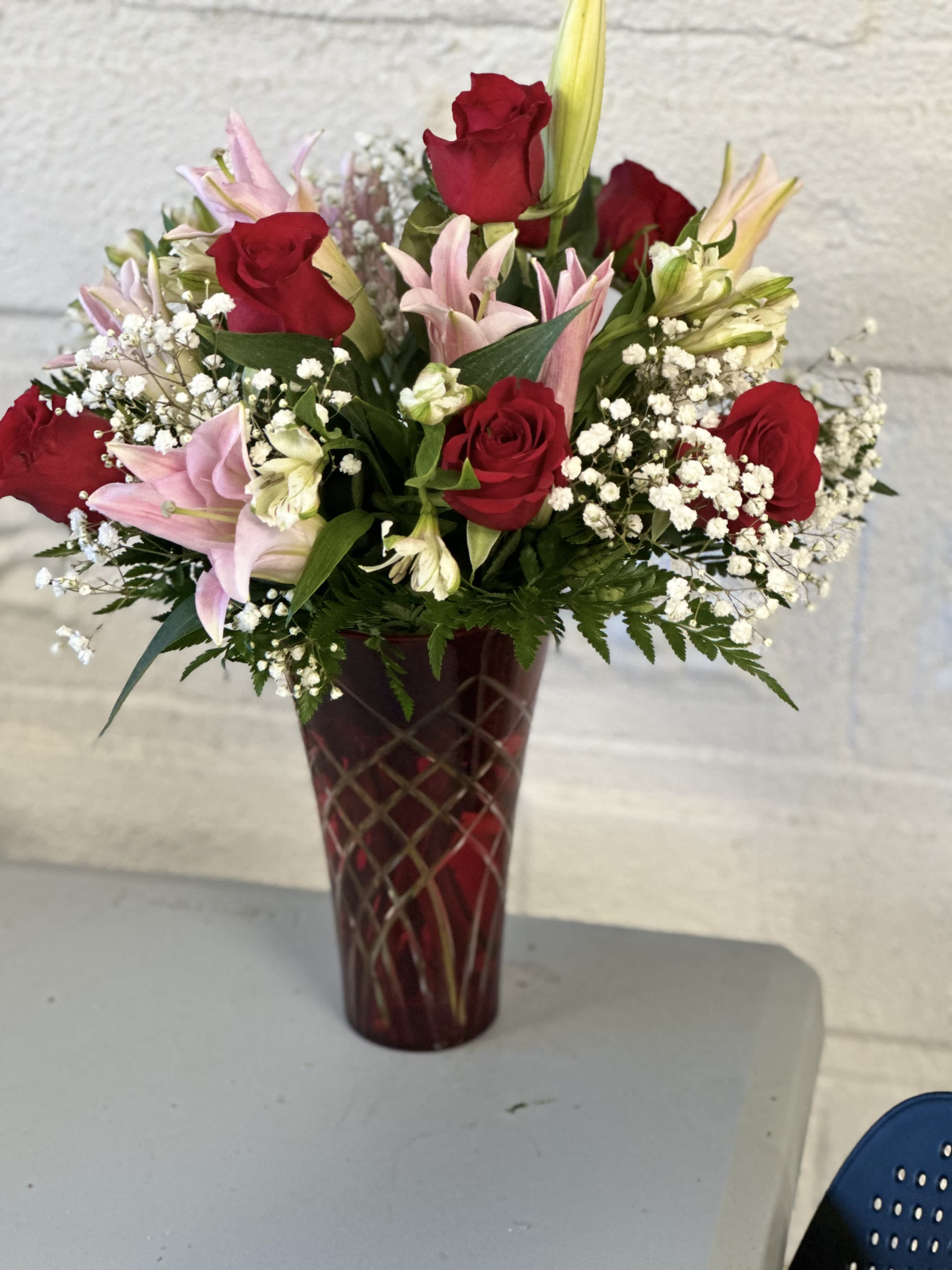 Crimson Serenade Bouquet Crimson Serenade Bouquet - Vibrant red roses intertwine with delicate pink lilies, creating a symphony of color and fragrance. Soft baby's breath and fragrant stock flowers accentuate the arrangement, adding depth and texture to this enchanting display. Perfect for expressing love, admiration, or sympathy, this exquisite bouquet exudes grace and sophistication, making it a captivating centerpiece for any occasion.