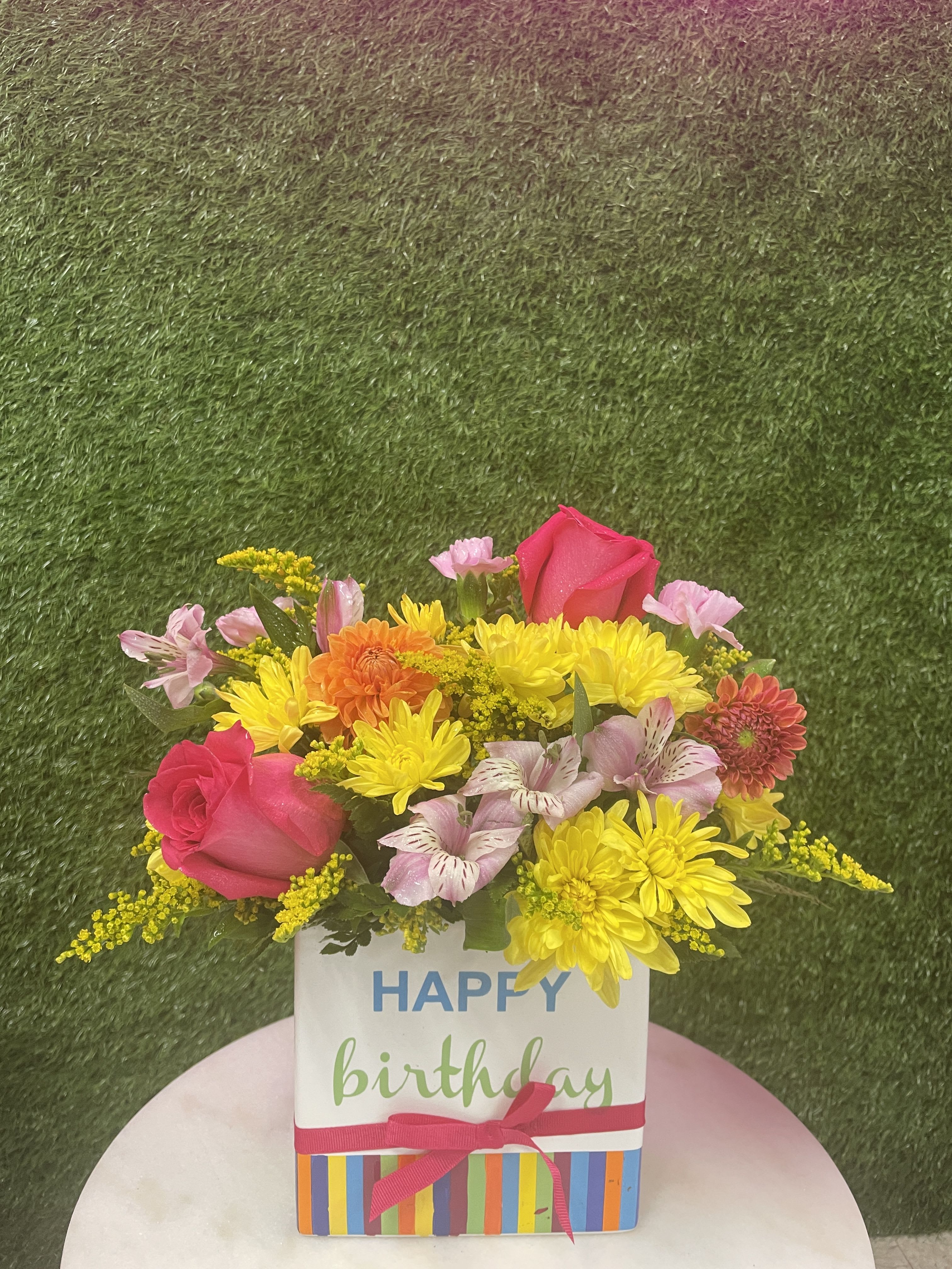 Happy Birthday Bouquet - A mix of colorful flowers in a happy birthday container. 