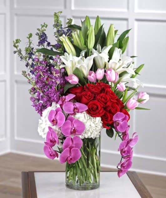 You're The One You're The One - Show her how special she is with a luxurious surprise of long stem red Ecuadorian mountain roses, delicate delphiniums, Oriental lilies and exotic orchid sprays bursting from a cloud of hydrangea. Our arrangements are unique, custom gifts designed by hand. Mother Nature changes our farm-fresh inventory every morning; to assure your gift is fresh and gorgeous our artists may need to make substitutions but will capture the color & style of your selection to deliver a "WOW" for your recipient.