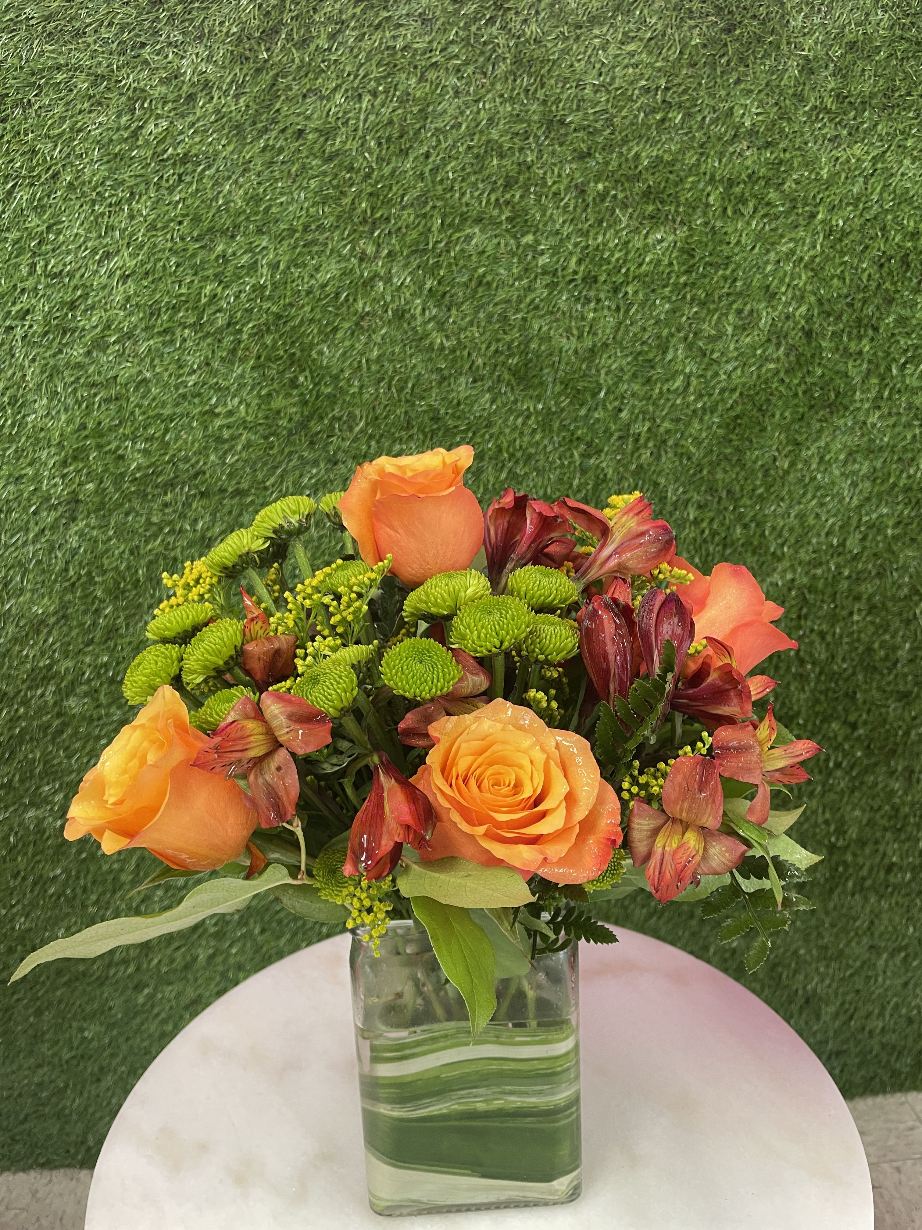 Contemporary Autumn - This autumn classic is sure to delight! With lovely orange roses, dark orange alstroemeria, green buttons and more, Contemporary Autumn is full of the season's best colors. Send this beautiful fall bouquet to someone who loves the season!